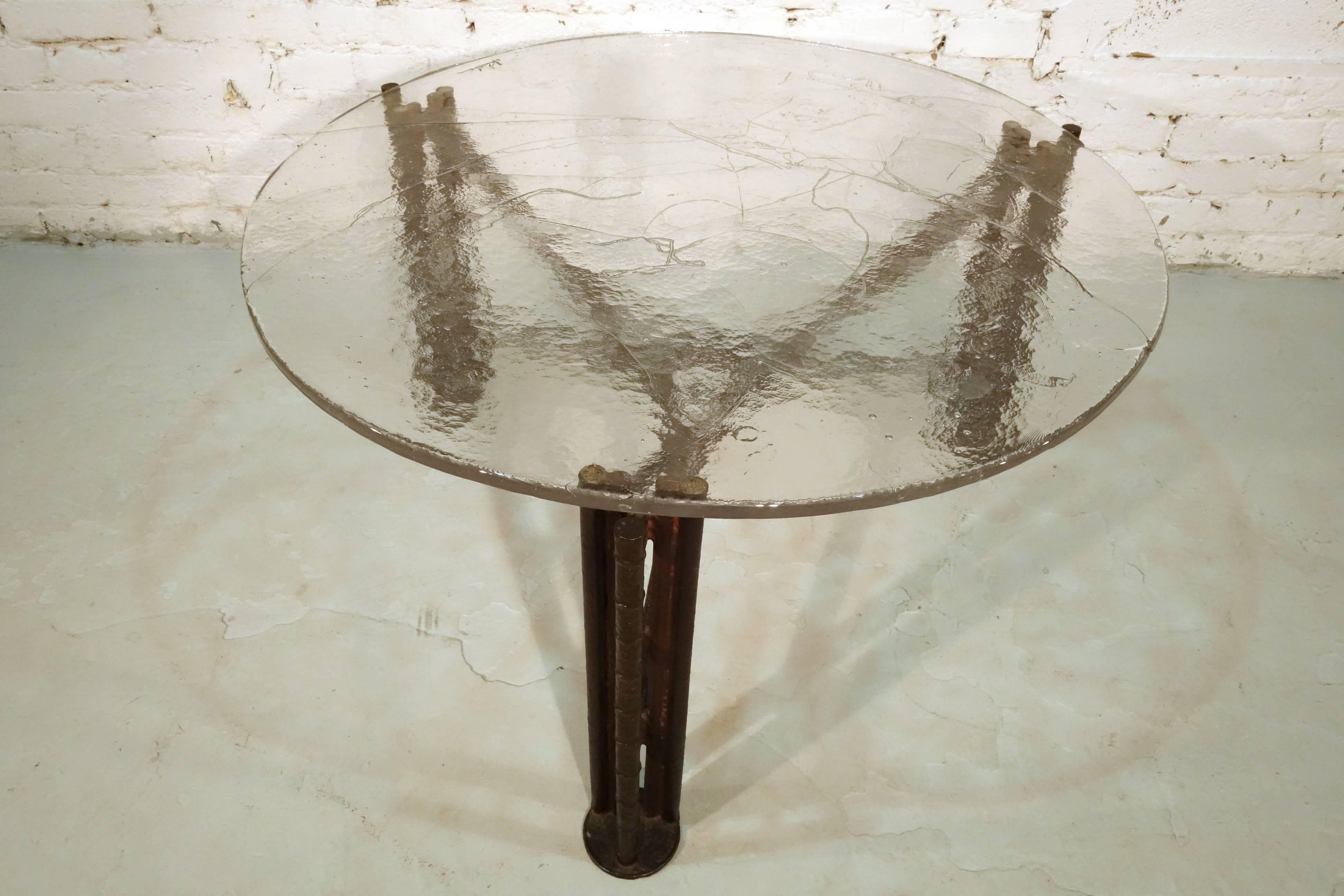 A bronze and glass low table by Lothar Klute

The bronze tripod showing elements of both the brutalist style as well as the influence of Claude Lalanne. The signed glass top fitted in between the leg posts.