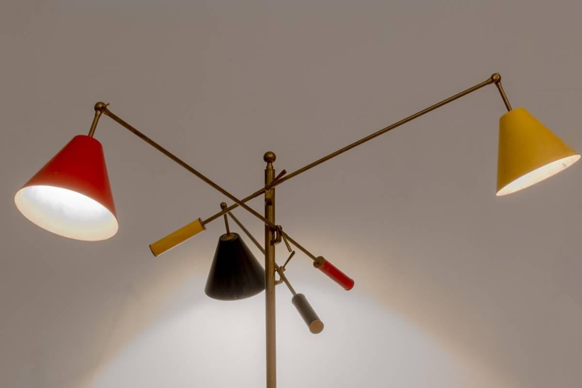 This triennial floor lamp designed by Italian Angelo Lelli in the 1950s has lampshades in three colors. Structure is a lacquered and chromium-plated metal. Manufactured by Arredoluce.
