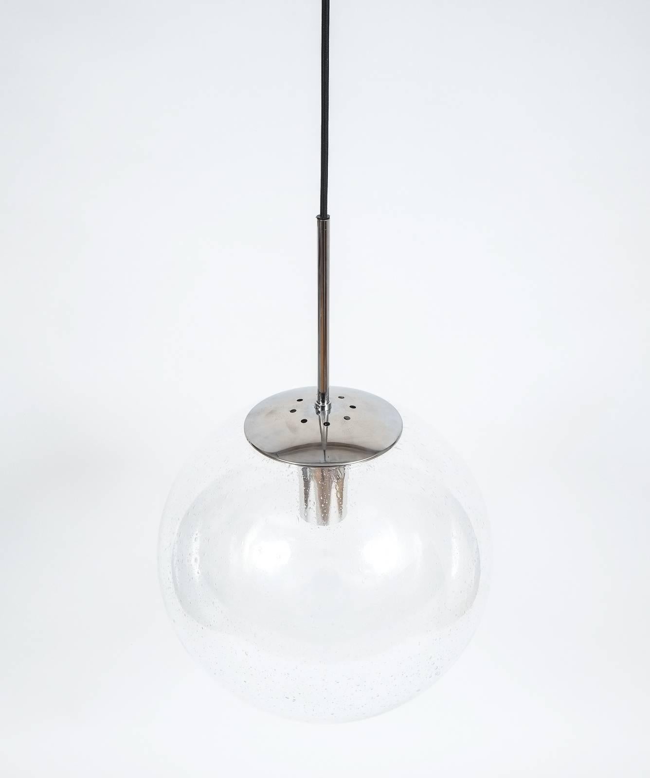 Glashütte Limburg Large Clear Glass Ball Pendant Light Lamps, circa 1960- priced individually

Beautiful set of four (4)  16 inch globe pendants by Glashütte Limburg/Germany featuring a clear glass globe and polished chrome hardware, which can be