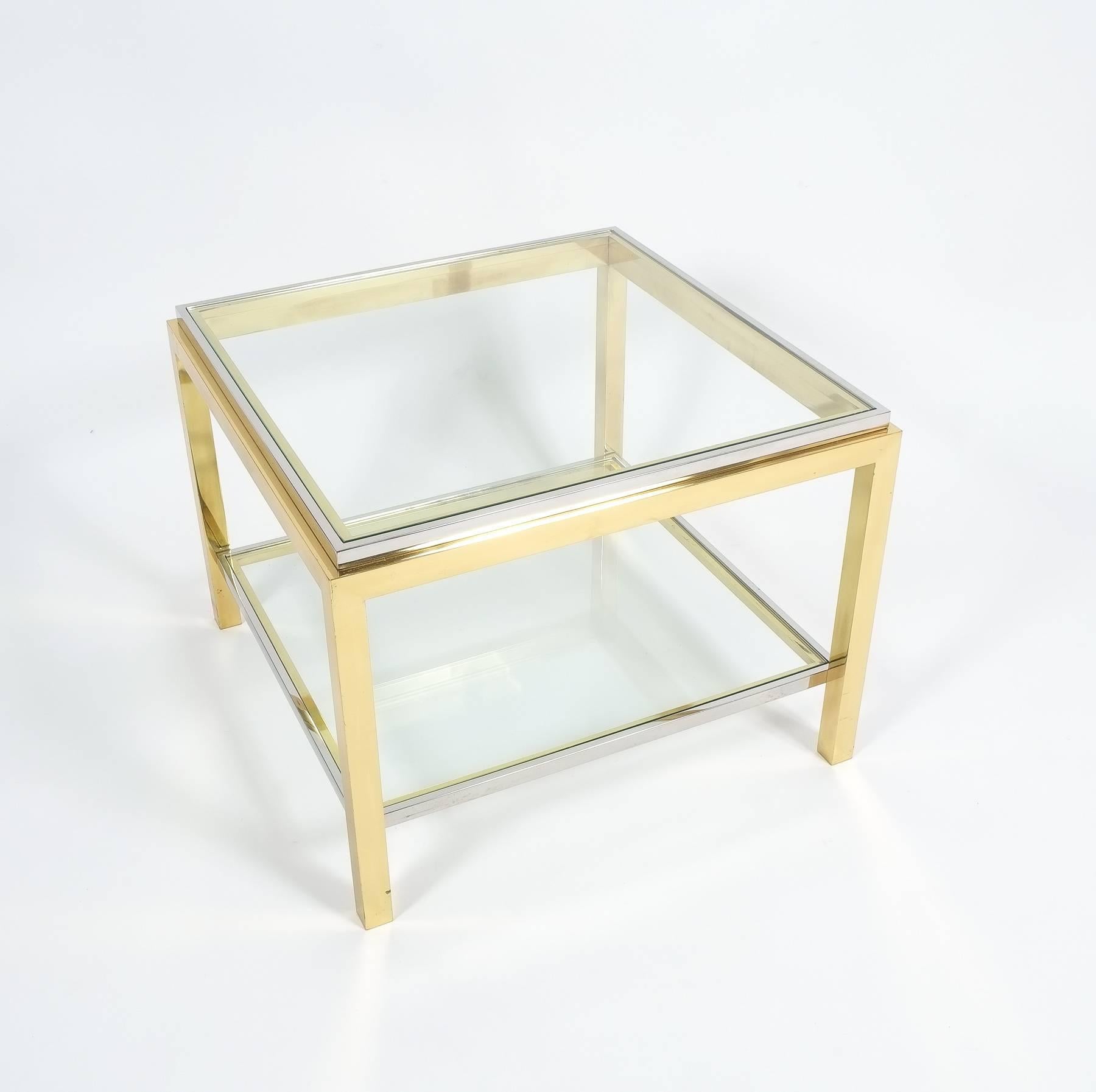 Nice 24 inch two tray coffee table by Maison Jansen, France, circa 1960. It has been made from polished chrome and brass and is in excellent condition.