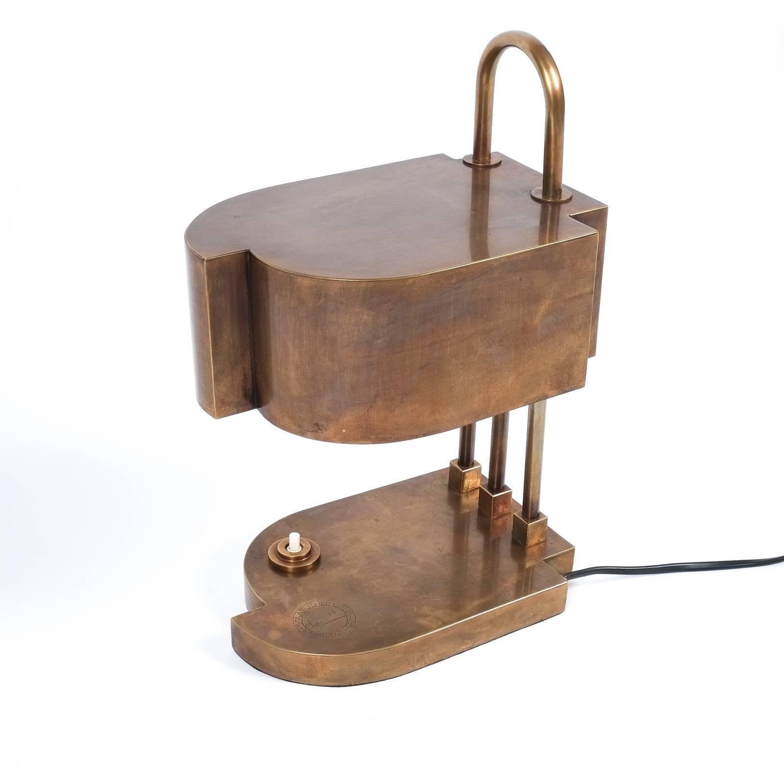 Beautiful and rare table lamp by Marcel Breuer featuring an asymmetrical base and shade. It's made from brass, marked 
