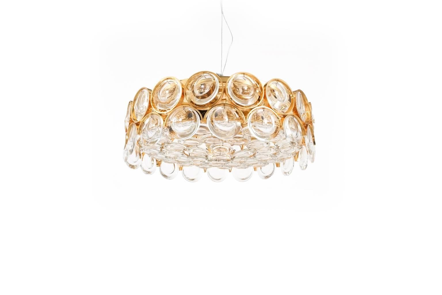 Palwa Gold Brass Glass Flush Mount Ceiling lamp, Germany 1960, composed of two rows of gilt brass rings with optical glass circles. Bottom surface fully covered with suspended glass pieces. The light has been professionally restored and rewired