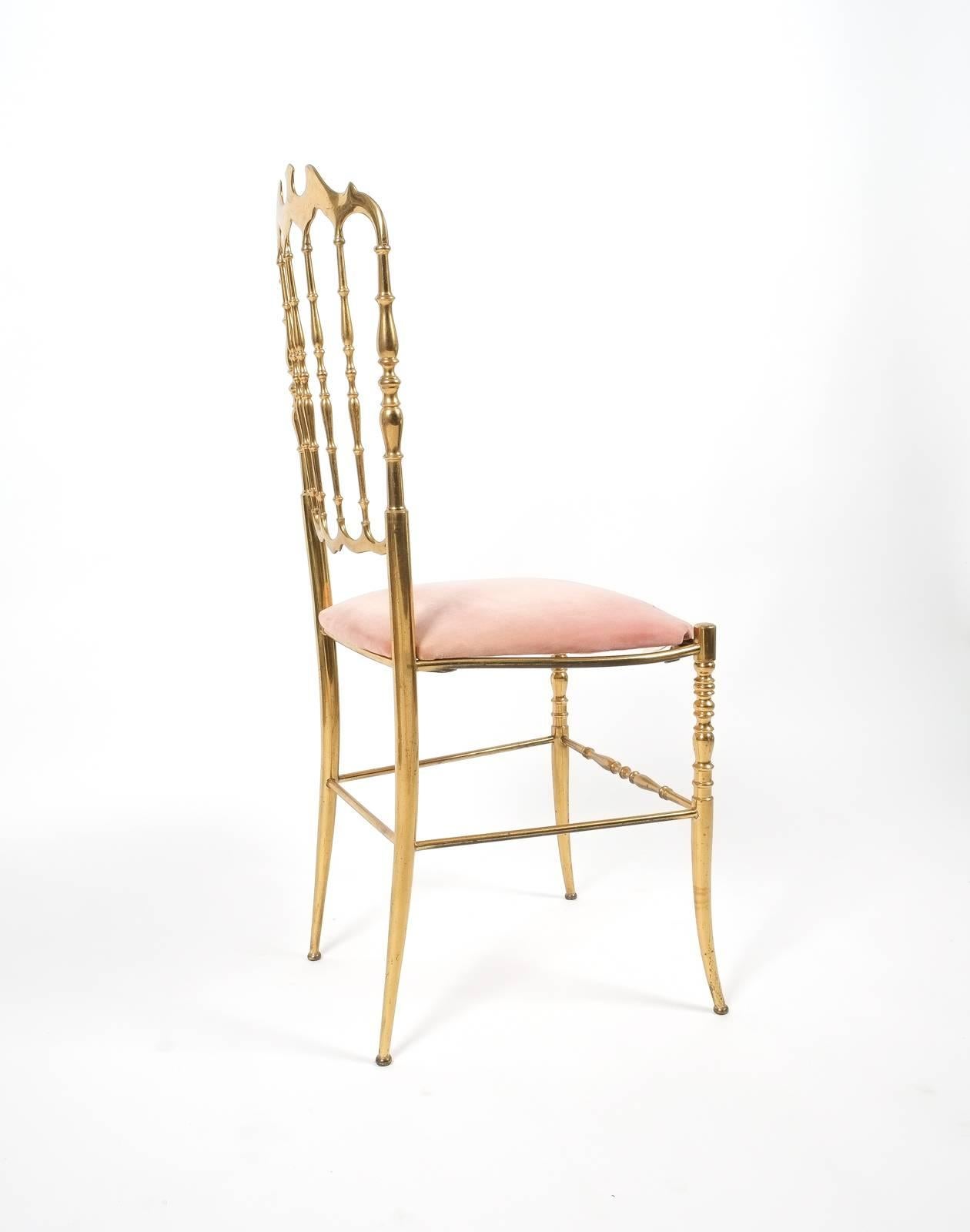 Beautiful solid brass chair by Chiavari, circa 1950. It shows a very nice golden patina and has got a rose velvet upholstery. The condition is very good.