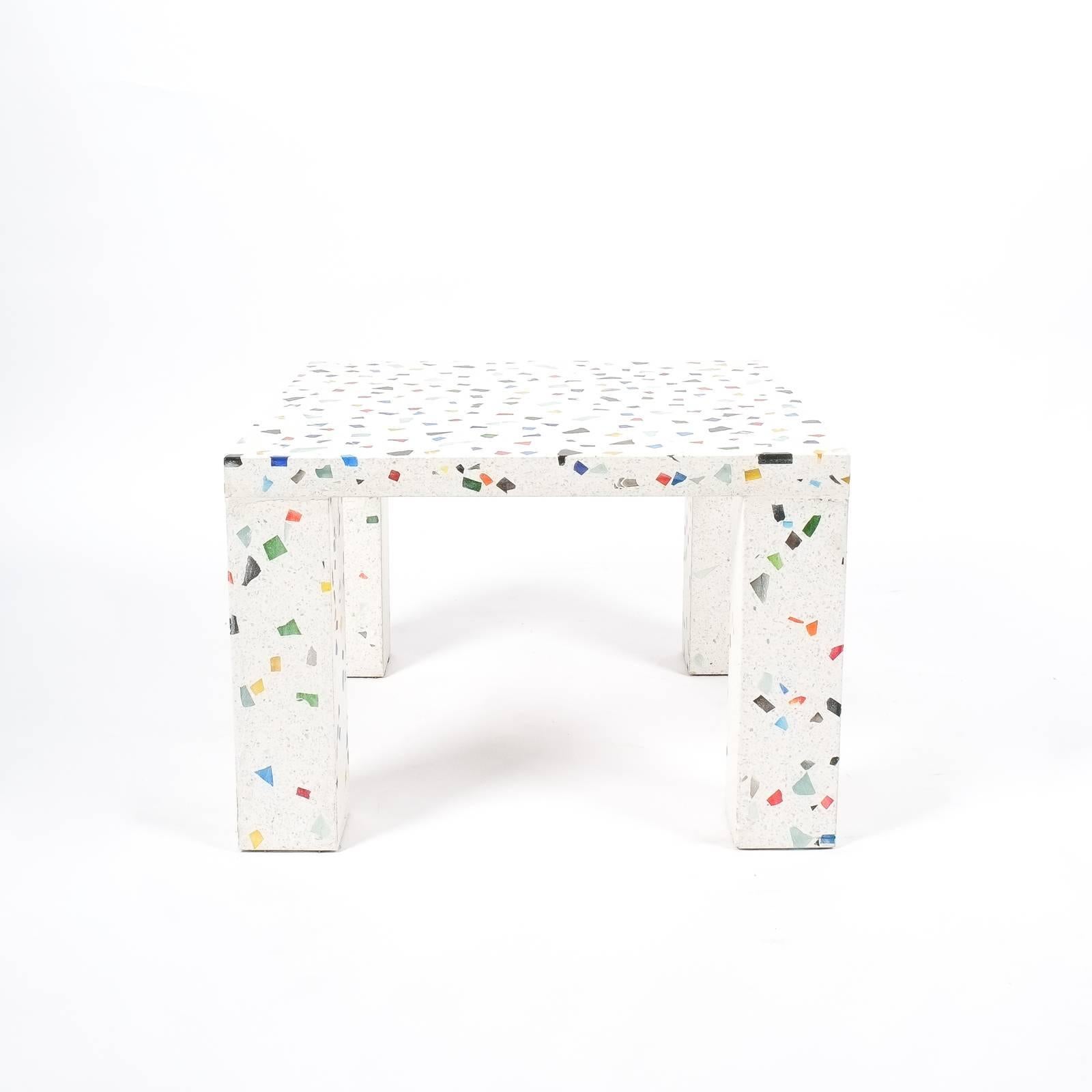 Postmodern iconic terrazzo table by Shiro Kuramata for Memphis, 1983. Very heavy solid square table made from colored glass infused terrazzo. The condition is good, one glass piece is missing. Dimensions: W 23.63 x D 23.63 x H 15.74.

 