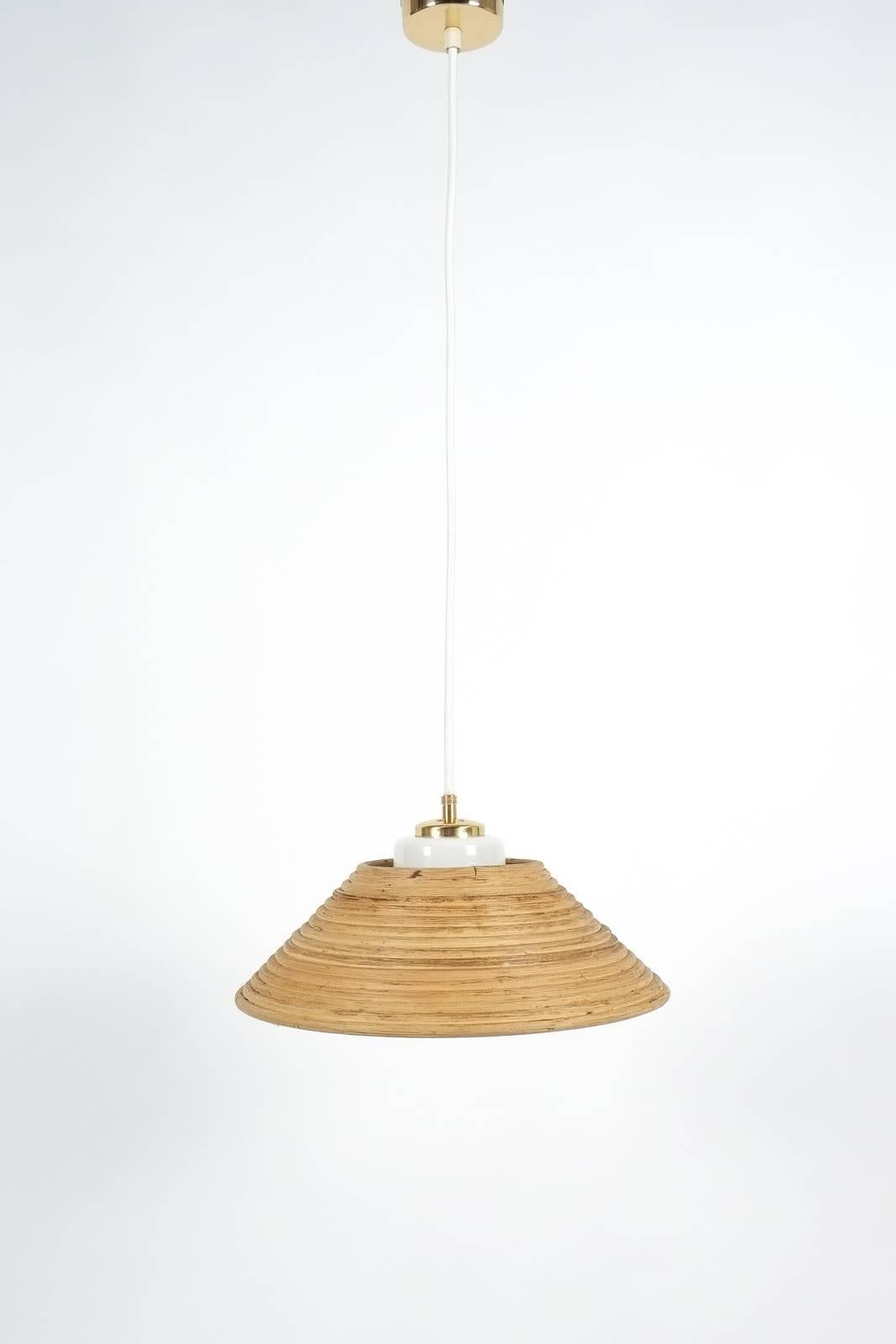 Rattan Opal Glass Pendant Lamp by Doria, 1960. Only one piece of these 13.38 inch rattan lights is left. Featuring a bended rattan and opaline glass shade, this light is perfect for over a kitchen counter/island or table. It's in great condition,