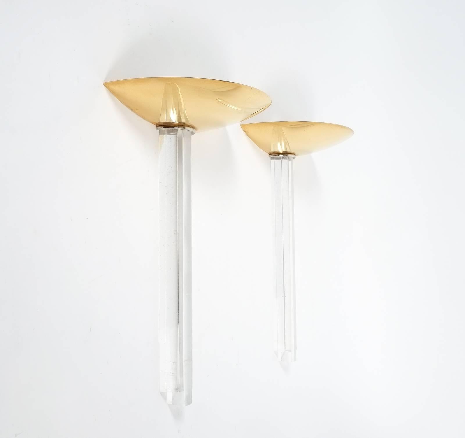 Lage pair of up-pointing lights Art-Deco style, France late mid century

Beautiful pair of very large 22 inch uplights in sthe style of Art Deco artist Jean Perzel. The lamps are comprised of gilt brass and Lucite and are in excellent condition.