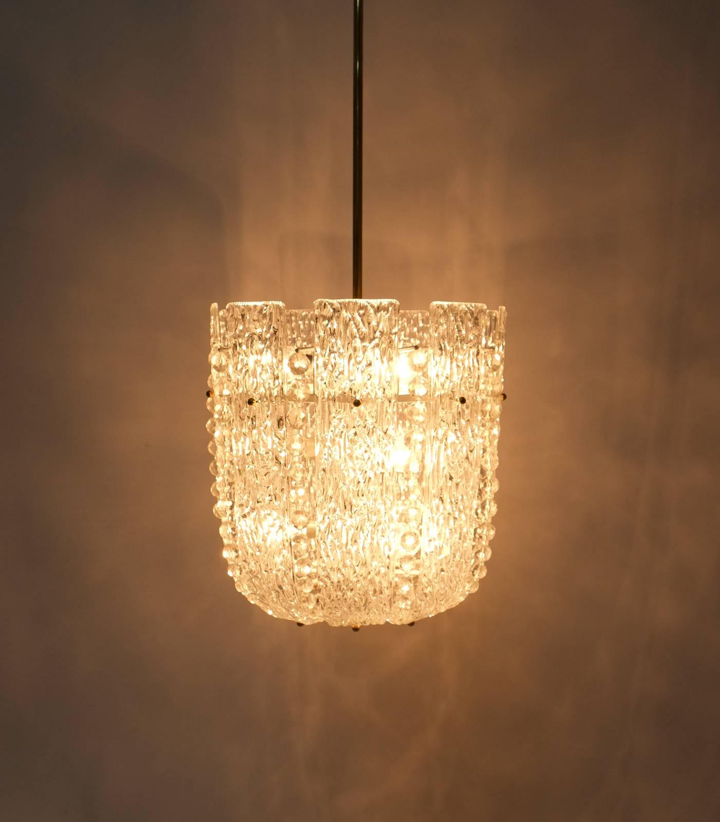 Stunning refurbished chandelier by Kalmar composed of large textured glass slabs and crystal pearls on an enameled brass hardware. The fixture has been gently refurbished and is in excellent condition, it has been newly rewired (US standards). Nine