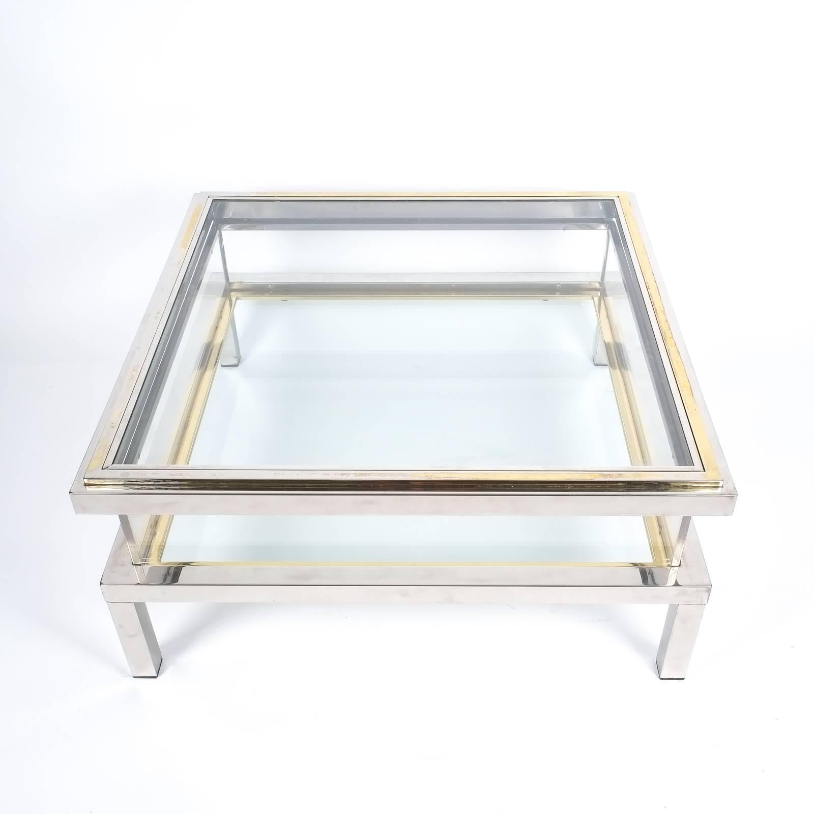Very elegant 1970s French chrome and glass table with brass accents to the glass top. Very solid quality 35 inch table with a sliding glass top to access the interior display case, ideal for presenting books or decorative items. It's in very good