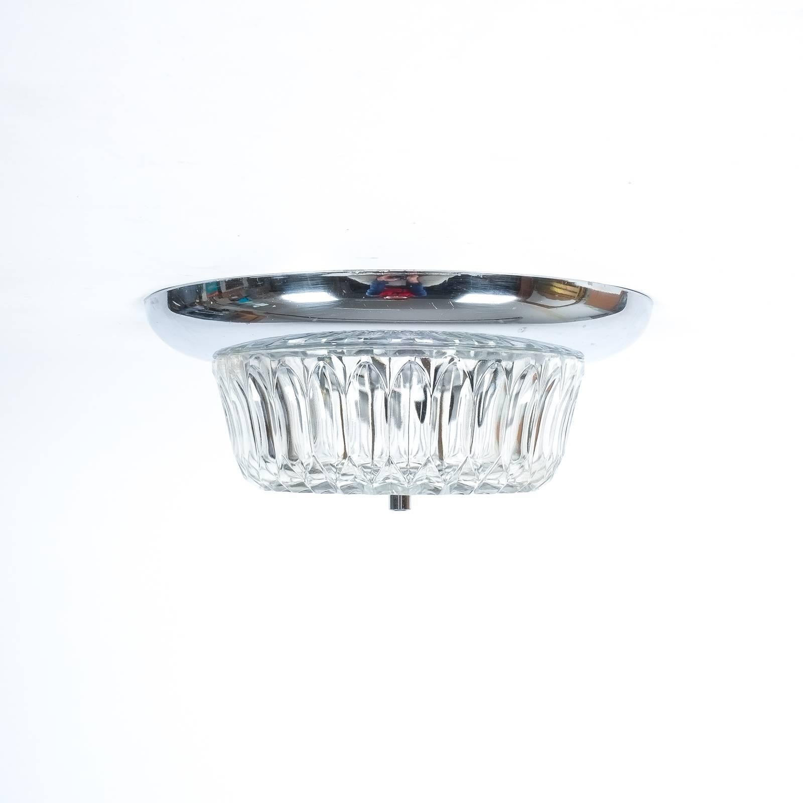 Beautiful set of three identical ceiling fixtures or sconces, Italy, 1970 featuring a chromed metal base with textured mould glass, two bulbs per light with e14 sockets and 40W per bulb, the condition is excellent, refurbished and rewired. Sold and
