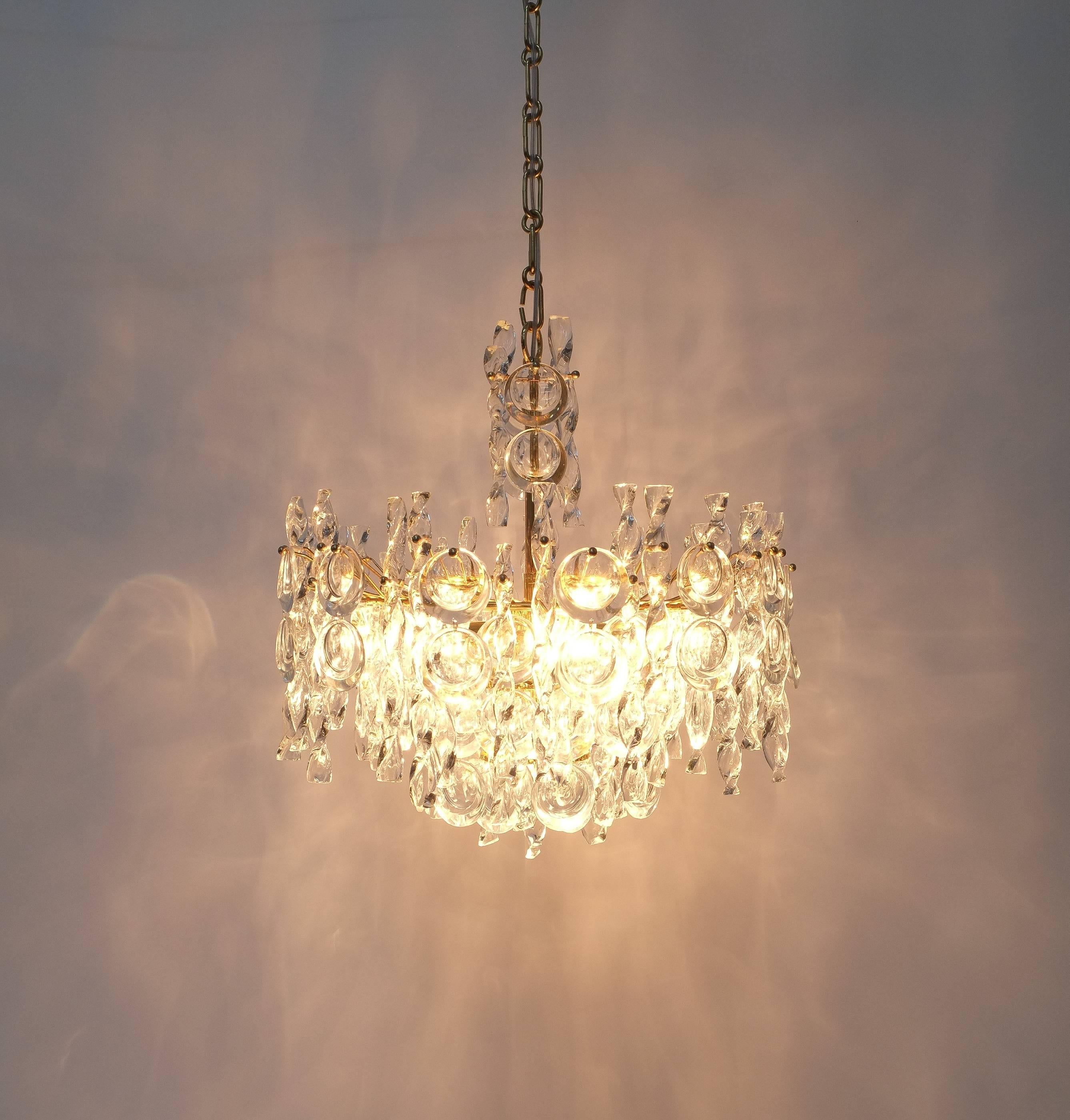 Beautiful refurbished 21 inch chandelier by Palwa, Germany 1960 comprised of glass tendril twisted ribbons and lens shaped crystals. The brass hardware has been newly gold plated. Classical yet minimalistic handmade piece executed with a taste for