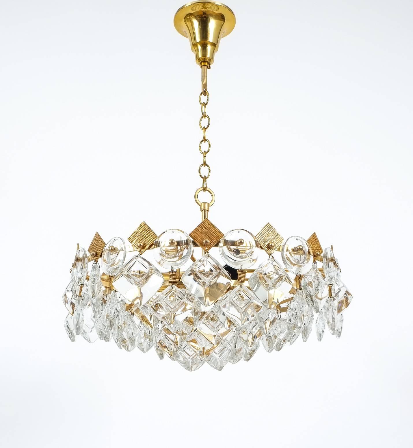 Delicate Palwa light composed of jewel-like circular and rectangular glass pieces and grained brass plates in excellent condition. The chandelier has been professionally cleaned/polished. It features four bulbs with 40W each. Led compatible. The