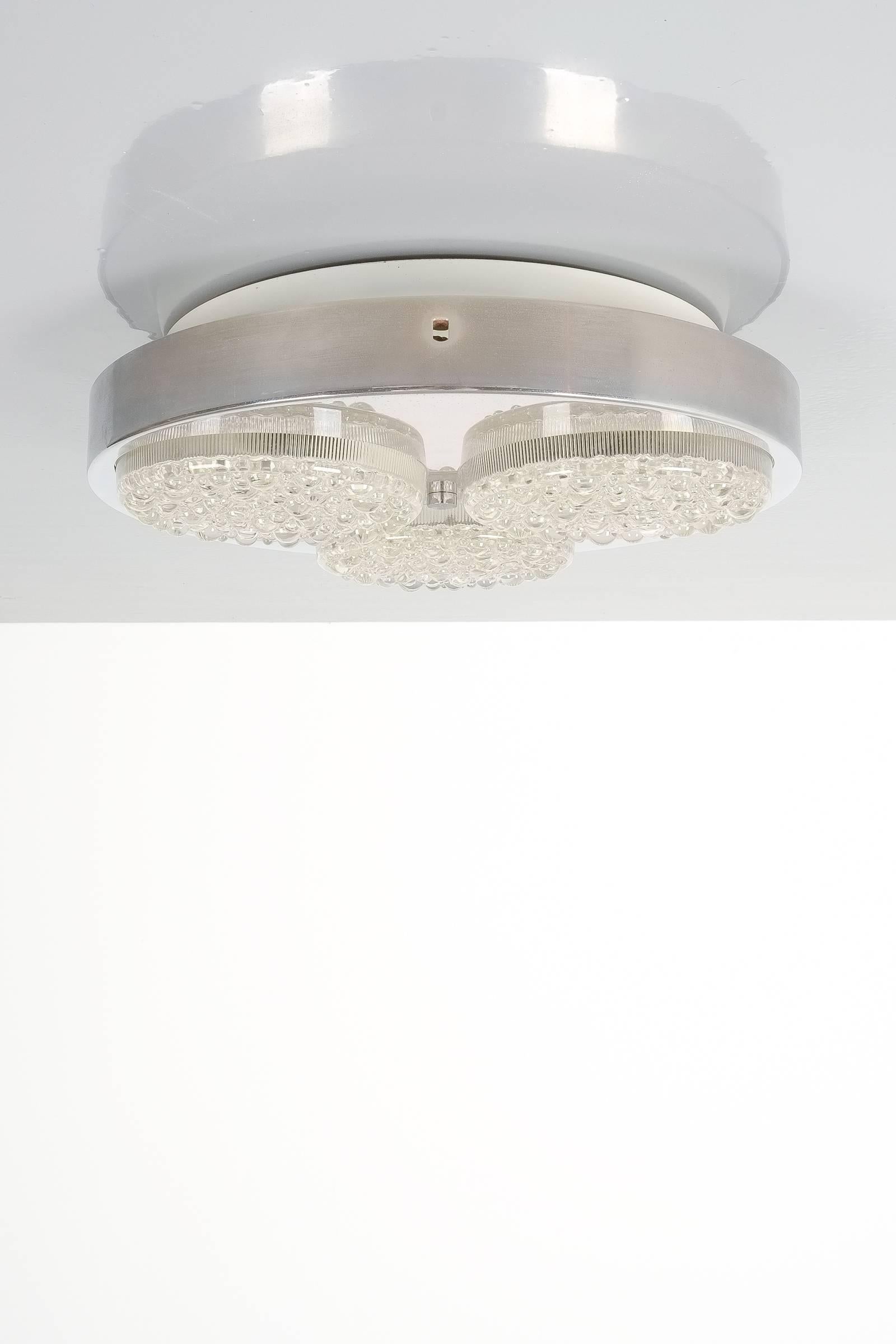 Textured Glass and Aluminum Flush Mount fixture light, Italy 1960. 14.2 inches in diameter, featuring 3 textured glass spots on an aluminum body with white enameled metal base. It takes 3x e14 bulbs with 40W max (supports Led) Measurements are 14.2x
