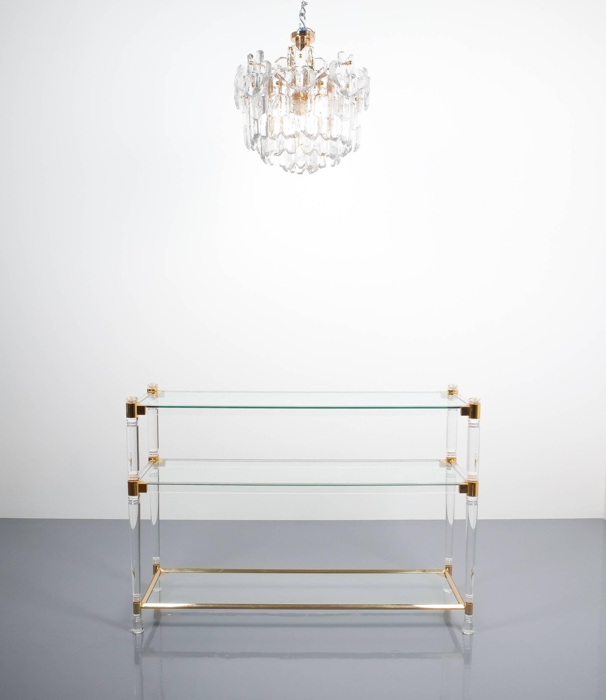 Romeo Rega console table Lucite glass gold brass, 1970. Classical console table by Romeo Rega consisting of round Lucite pillars and gilt brass joints. Three clear glass trays. The table is in excellent condition, minimal traces of use.