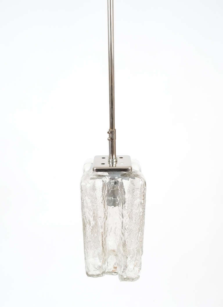 One of circa 30 Austrian Grenada clear glass pendant lamps by J.T. Kalmar, circa 1950.

Sold and priced per piece, discounted greatly if multiples are being ordered.

Identical set square clear Grenada pendant lights by J. T. Kalmar with chrome