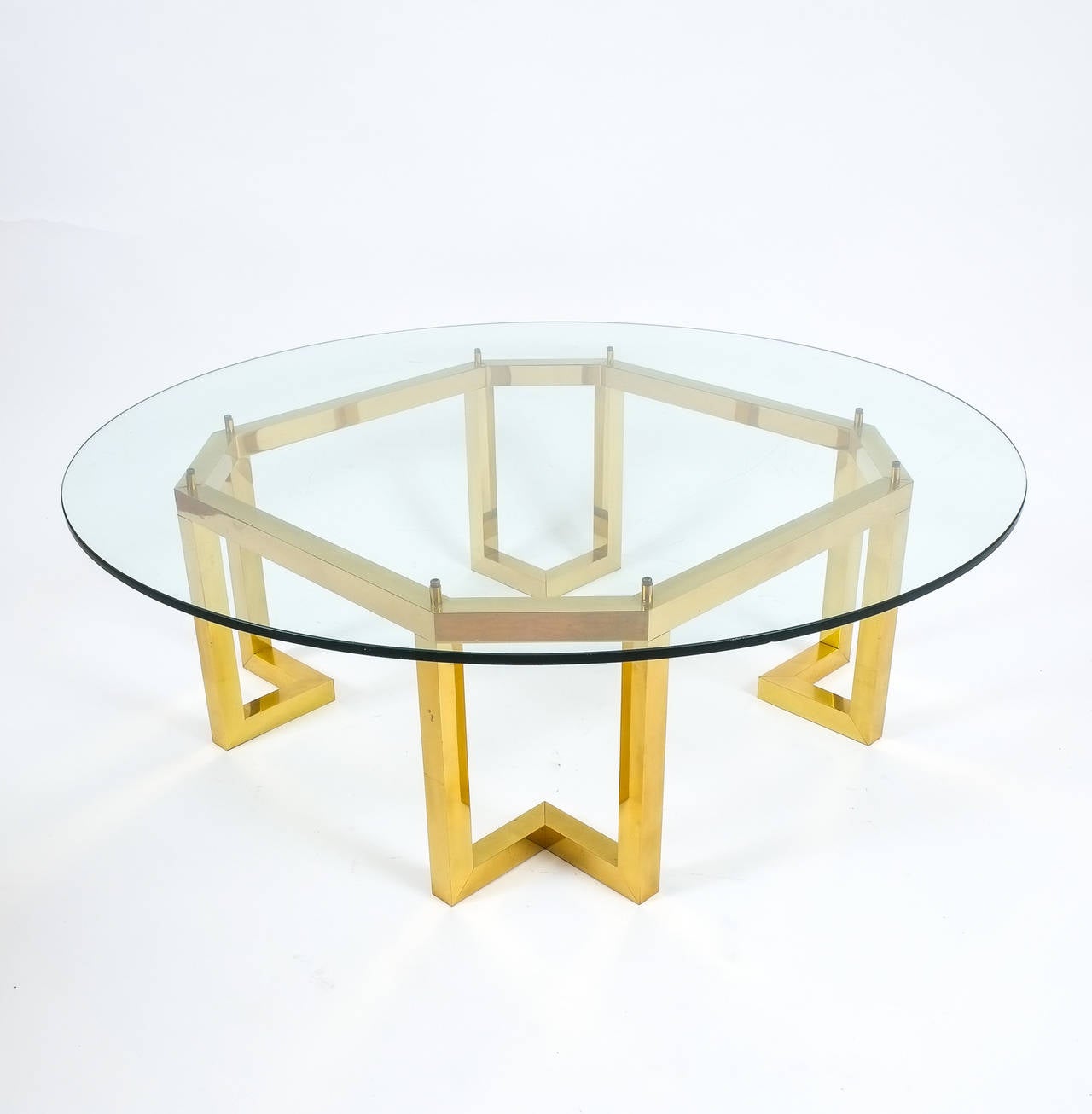 Excellent pair of early 1980 large brass tables featuring an octagonal brass base and a hovering glass tabletop. The tabletop as pictured measures 47.24 inches in diameter and is an optional feature.