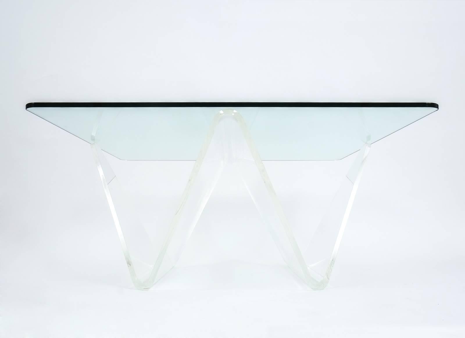 Large and very elegant Lucite and glass table consisting of a thick bended Lucite sheet and a glass tabletop. The condition is excellent. The base could easily carry an even larger customized tabletop, which we could provide of course, please