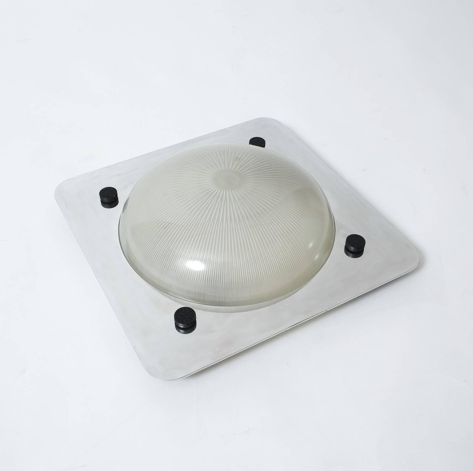 Very elegant ceiling fixture or wall light designed by Sergio Mazza for Artemide. 
We have two available in different sizes. White enameled metal base in with a mounted polished metal frame and glass dome. The condition is excellent vintage, newly