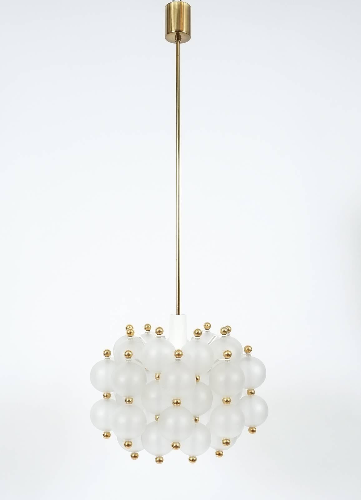 Glass chandelier by Kinkeldey, circa 1980. Beautiful and large chandelier with a multitude of smooth translucent handblown glass balls with golden brass knobs. The fixture is in very good condition (fully restored) and holds a sinlge bulb with 150W