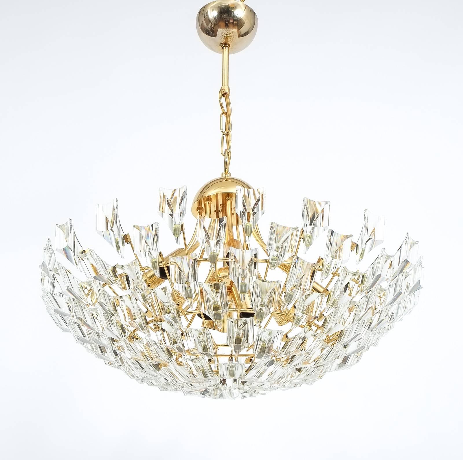 Large glass and brass chandelier by Stilkrone, circa 1970 with gold-plated brass hardware and a multitude of crystals. 12 bulbs (40w each) are illuminating this piece. The condition is excellent.