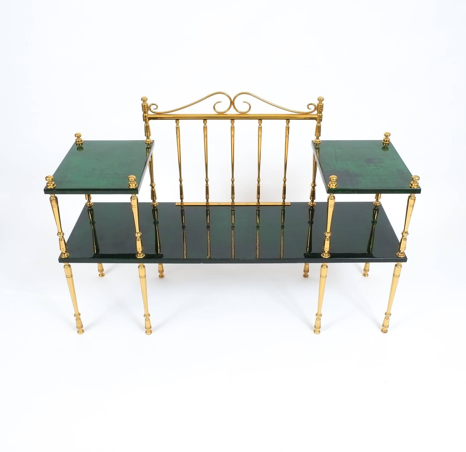 Beautiful bench table by Aldo Tura in excellent condition. Comprised of green dyed parchment and solid brass pillars this piece is a marriage of console table and bench and perfect for a foyer. The condition is excellent with few traces of use. 