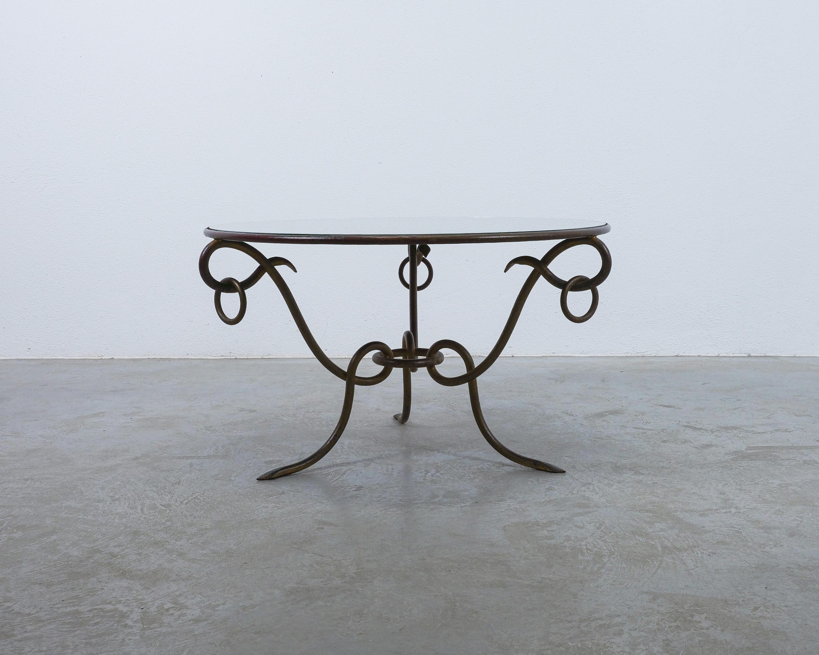 Magnificent French gilt iron coffee table with mirrored top by René Drouet (1899-1993)

This round forged gilded iron coffee table was designed by René Drouet the 1940s and probably executed in the 1950's. The base is made of forged iron with its