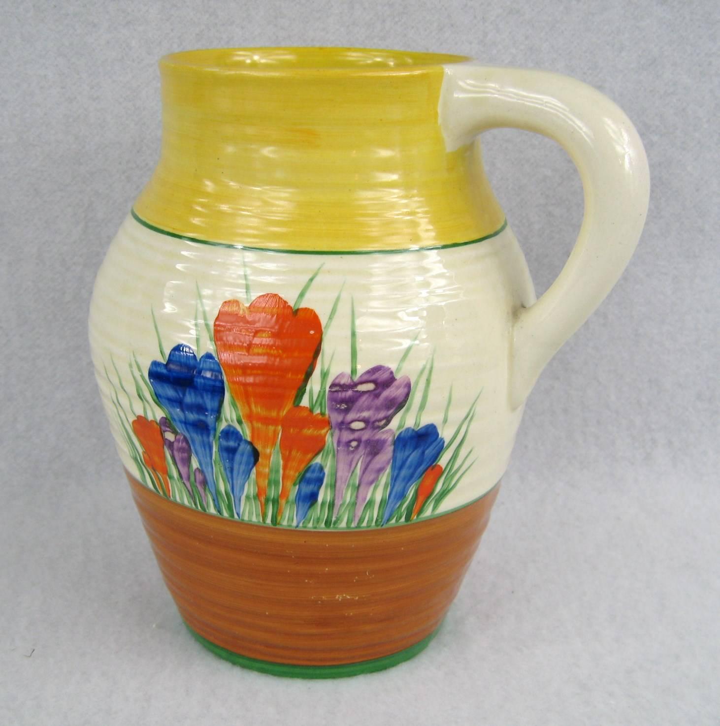 Stunning colors on this Clarice Cliff jug. Vibrant blues, reds, yellow and green. In wonderful condition. This jug will make a fabulous addition to your home. Please check our storefront for more decor from early primitive, rustic, Americana,