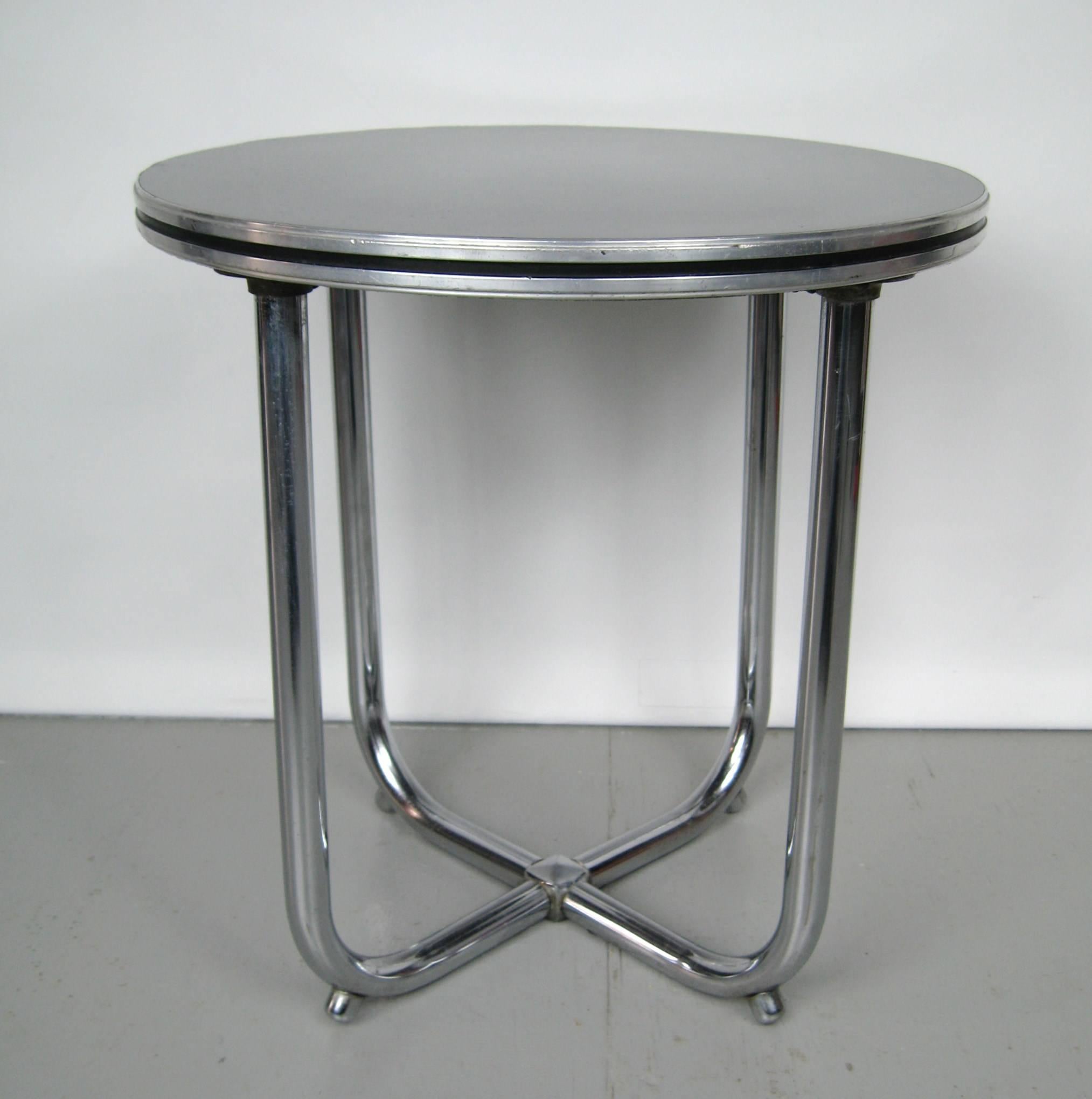 Wolfgang Hoffmann Art Deco chrome black side table. Another stunning Art Deco side or end table, chromed metal tubular U-shaped legs that meet at the floor to make an X-pattern. With black laminate Micarta top. Be sure to check our storefront for