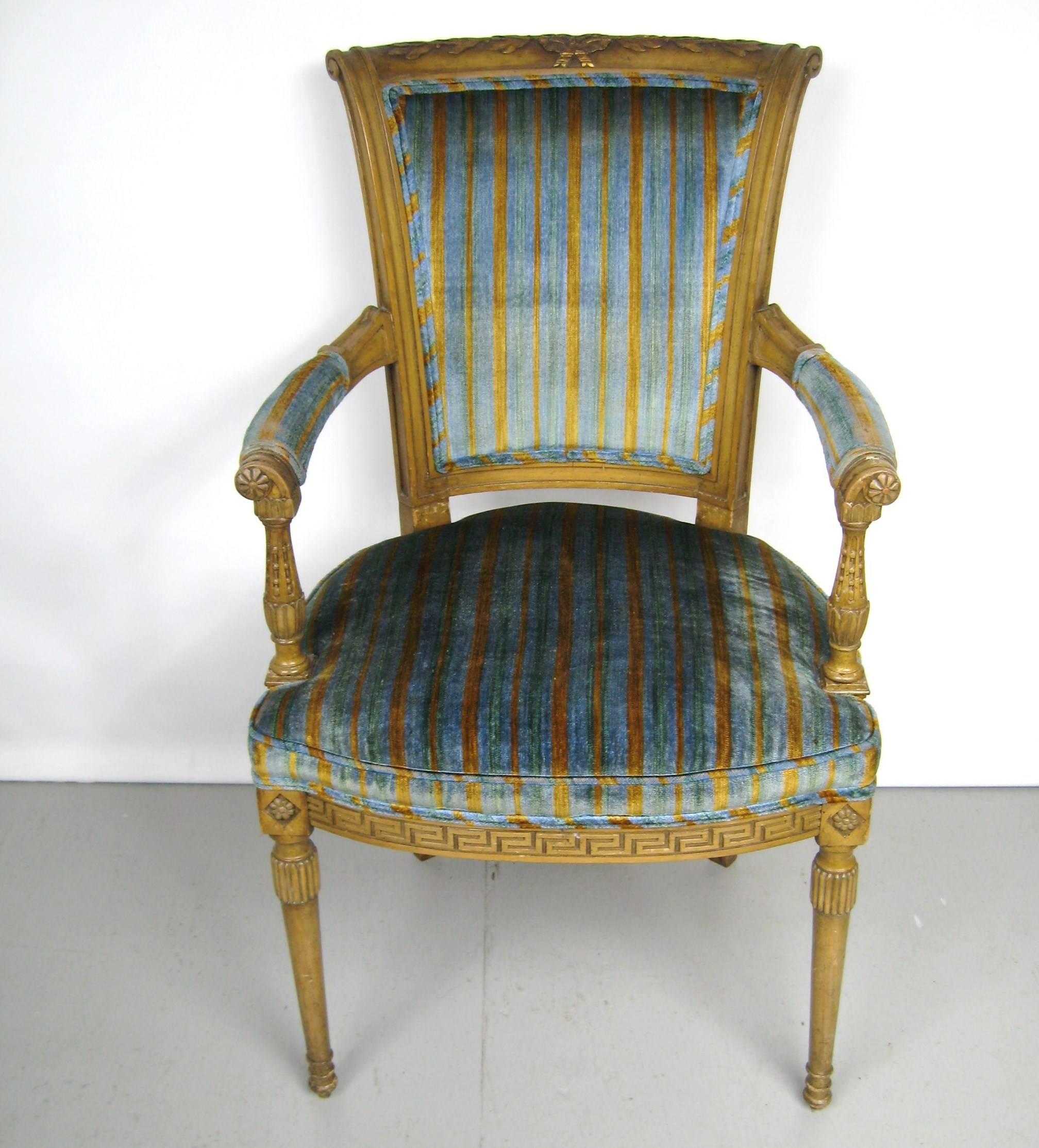 The structure is made out of carved wood enhanced with floral detailing at the top and Greek Key motif at the base of the seat. Striped crushed fabric, in the Italian Louis XVI neoclassical style. Measures: 38 in high, 22 in wide, 24 in deep, 20 in