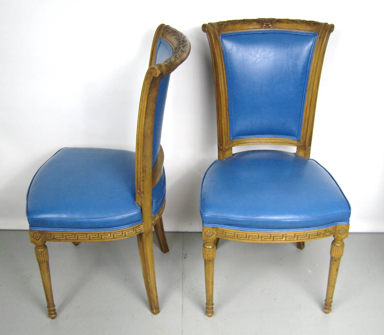 Two blue Italian Louis XVI neoclassical style chairs. The color on these is stunning. They measure 37 in H 23 in D 18.25 in wide, Seat height 18.5 in. We have a pair of captain chairs on our storefront that will go great with these. Please be sure