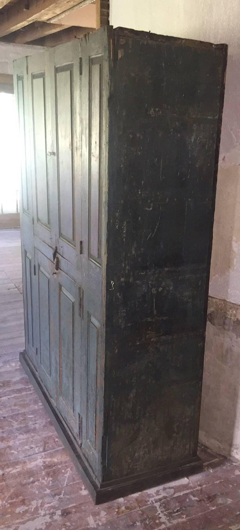 This is a wonderful large late 1700s blind door Hudson Valley cupboard, with original paint, it was dry scraped many many years ago.
It is in wonderful condition for its age. It has H hinges, some of which have been replaced with butt hinges many