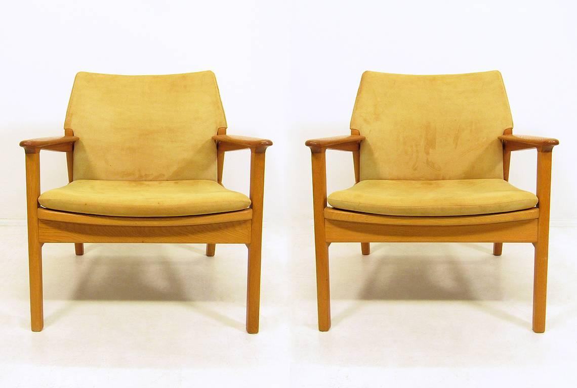 A pair of 1950s lounge chairs in suede, teak and beechwood by Hans Olsen for Verner Birksholm.

Designed in 1955, this striking design shows the influence of both Hans Wegner and Finn Juhl.

The beech frames are contrasted with finely contoured