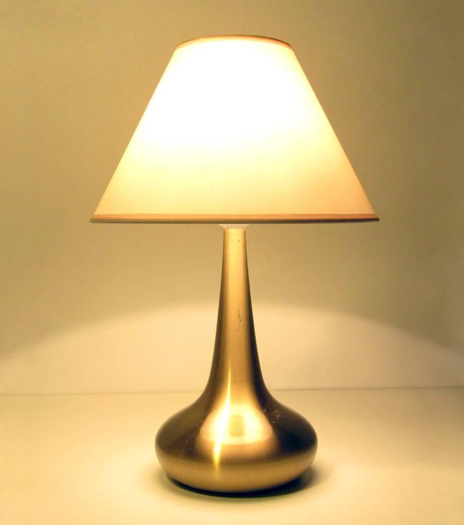 A 1970s "Orient" table lamp by Jo Hammerborg for Fog and Mørup.

The shapely gold-colored base is fitted with a new cream shade.

It is marked at the base with the Fog & Mørup stamp.

It is in good vintage condition, with minor