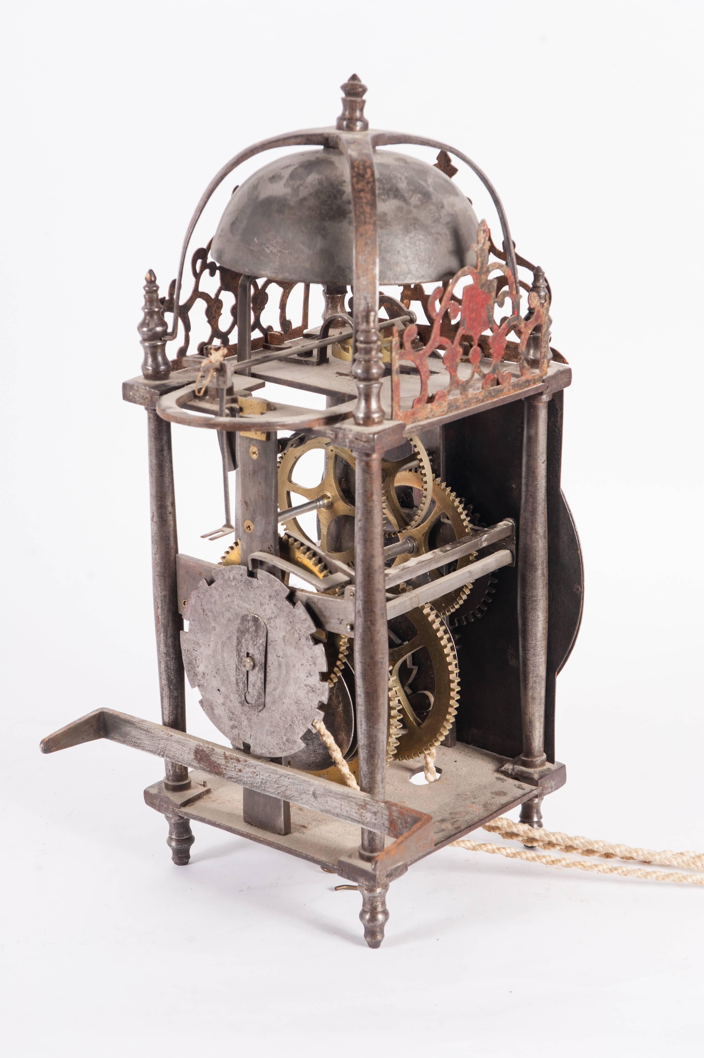 A highly important and impressive french country lantern clock. Unusual big size. The clock was made about 1720, also has going and striking train with verge escapement, very nice wrought iron craftsmanship. Clock topped with a giant bell mounted on