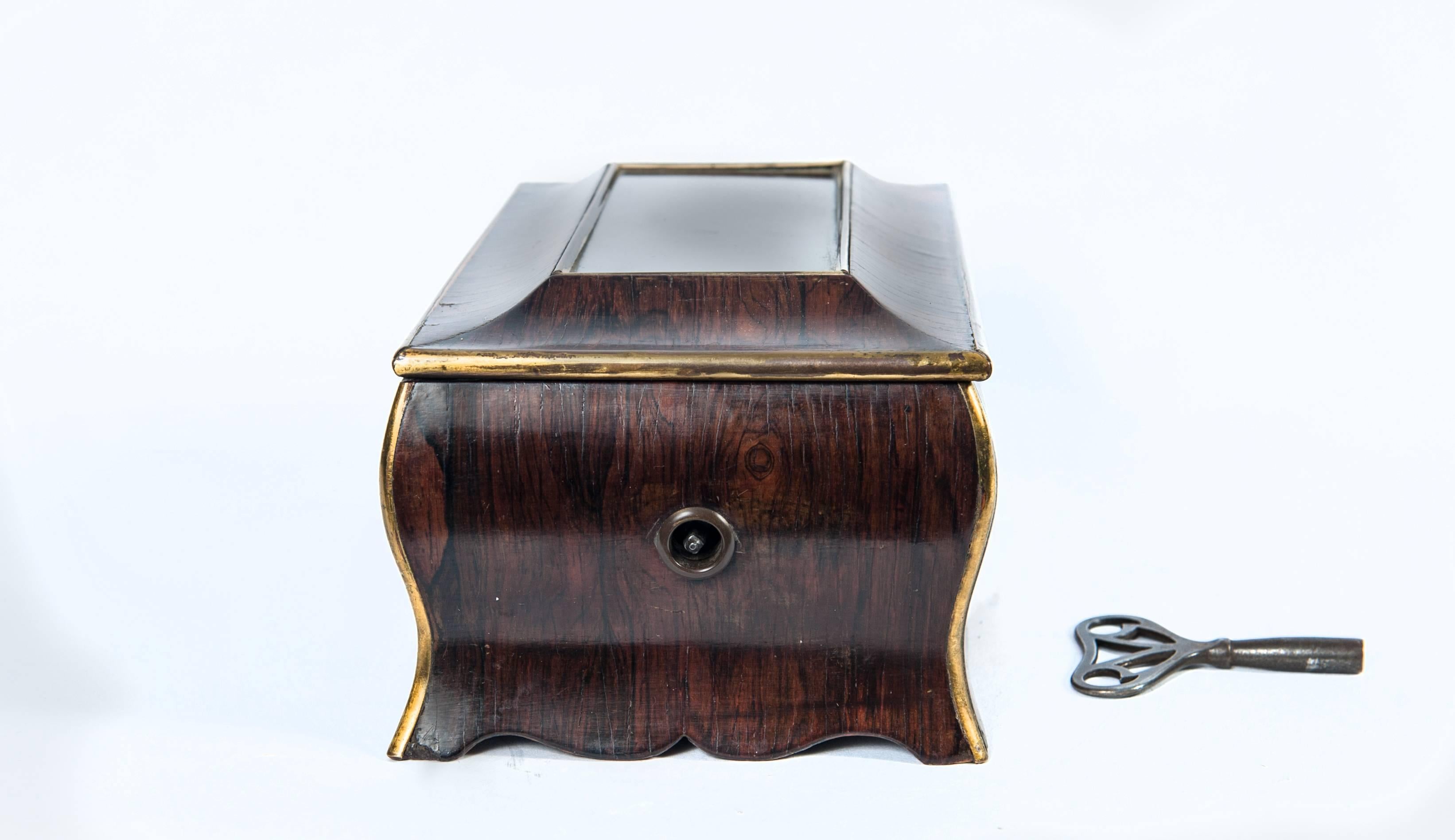 A good looking and good playing charming mid 19th-century music box in the shape of a commode, the two tunes key wind spring drove box is signed 