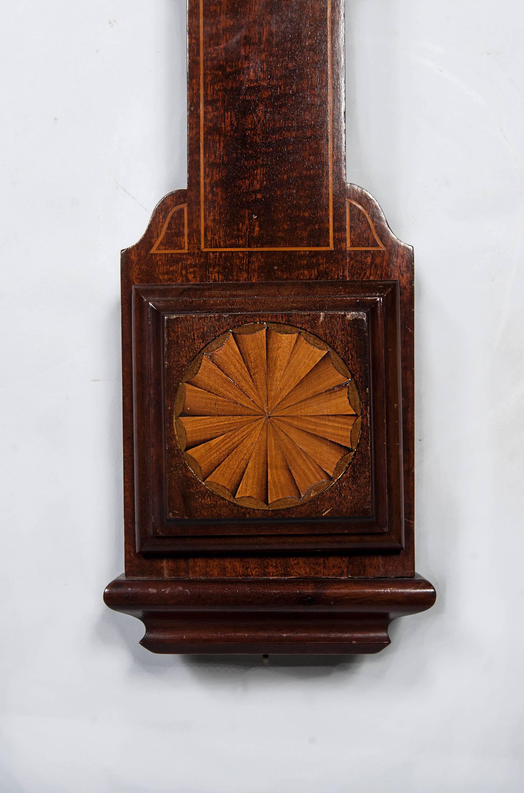 A good English mahogany marquetry inlaid stick barometer, J. Hicks London
bone scales with double vernier, mahogany inlaid case with the thermometer.

Concealed tube with bone scales signed J. Hicks London with double vernier, an arched mahogany