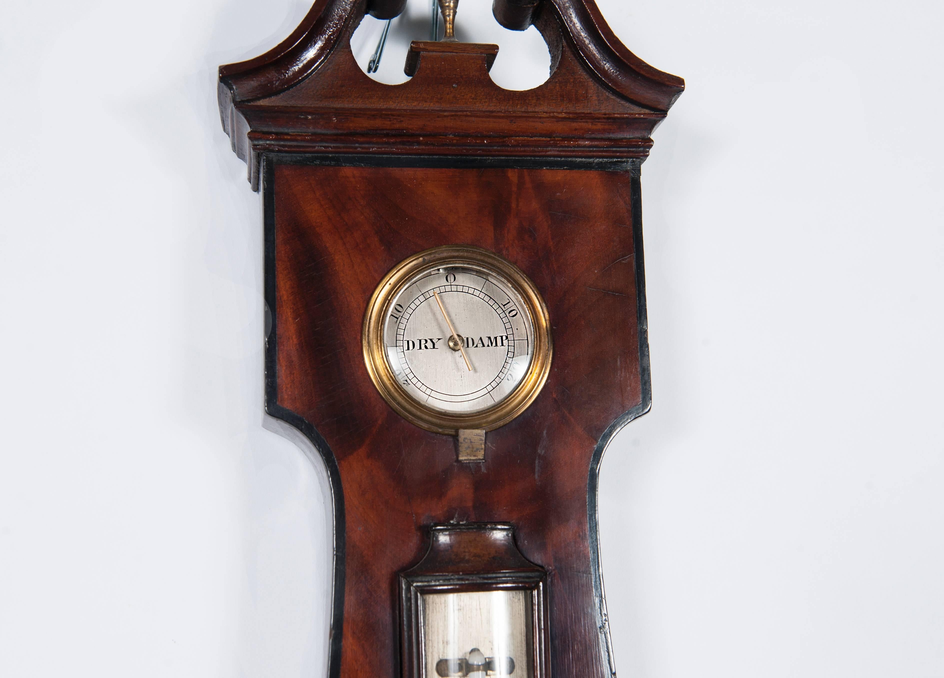 An imposing king-size wheel barometer by "Tarelli" New Castle, engraved silvered plates Mercury thermometer and separate hygrometer, signed "Tarelli New Castle," blue steel hand and brass vernier. Mahogany case with swan neck top