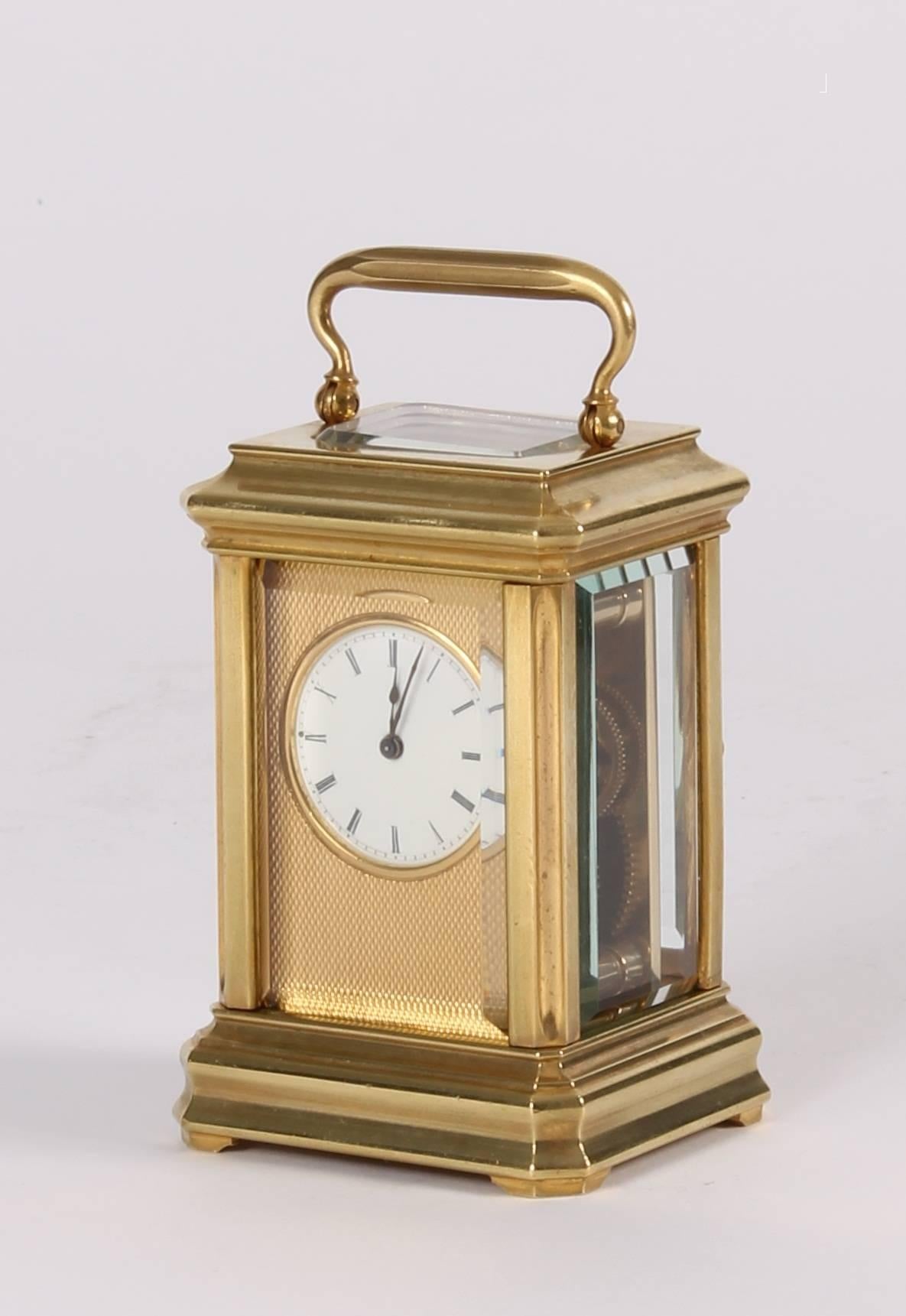 A lovely French miniature brass carriage timepiece, circa 1880.

2.8-cm enamel dial with Roman numerals and fine blued hands fitted in a machine turned gilt surround, 8-day movement with visible platform lever escapement, moulded brass case