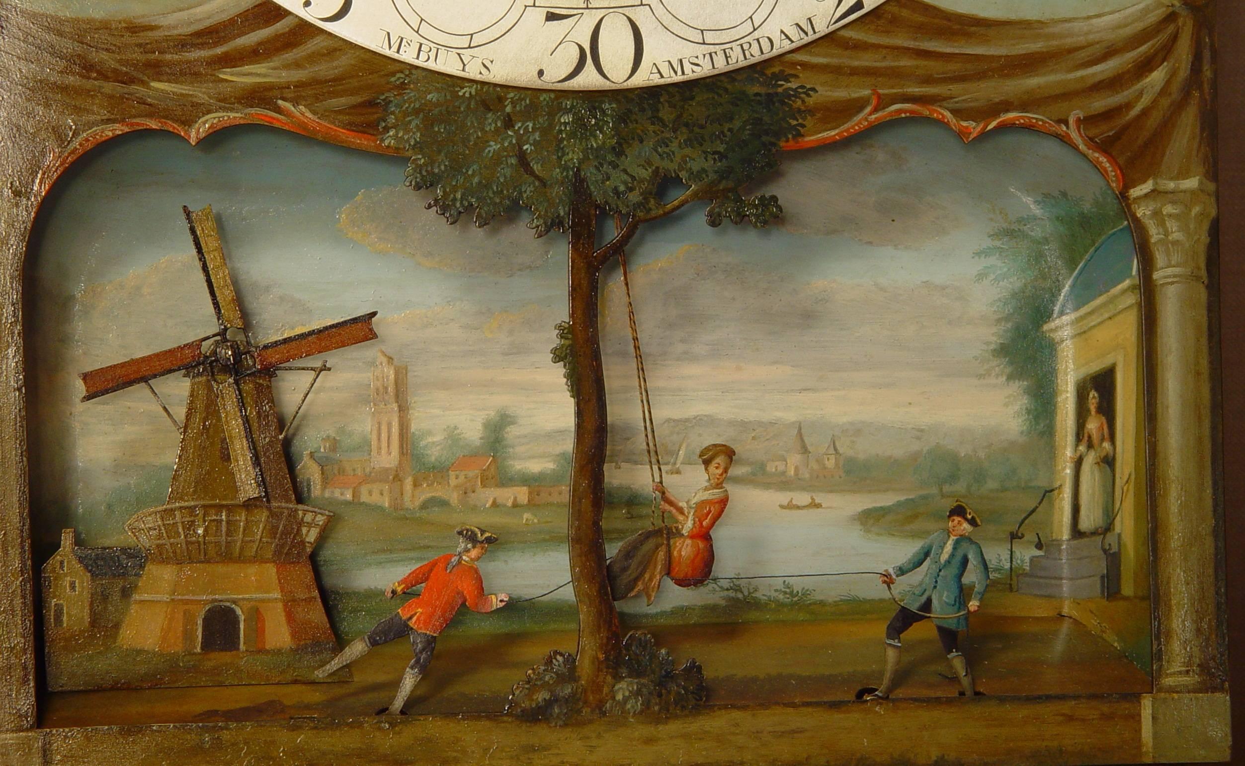 A Dutch burr walnut longcase clock with rare ‘swing automaton’ by M. Buys Amsterdam, circa 1775. 

33.5-cm brass dial with an engraved silvered chapter ring signed M.s Buys Amsterdam. The matted center with foliate scrolls below the penny moon