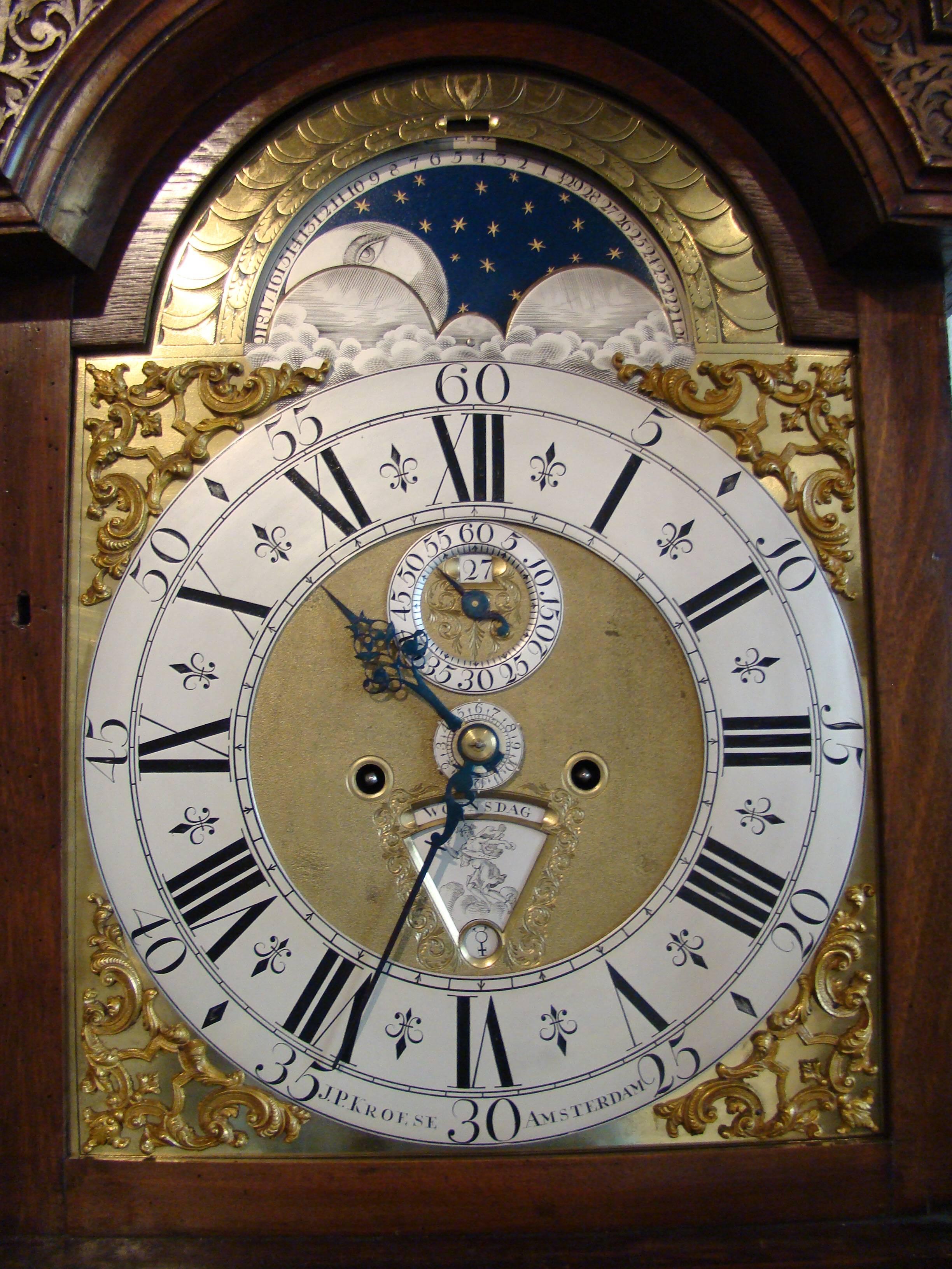 A fine Dutch burr walnut striking longcase clock J P Kroese, Amsterdam, circa 1730
arched brass dial with silvered engraved chapter ring with Roman numerals and half-quarter marks signed J.P. Kroese Amsterdam, pierced blued hands and silvered alarm