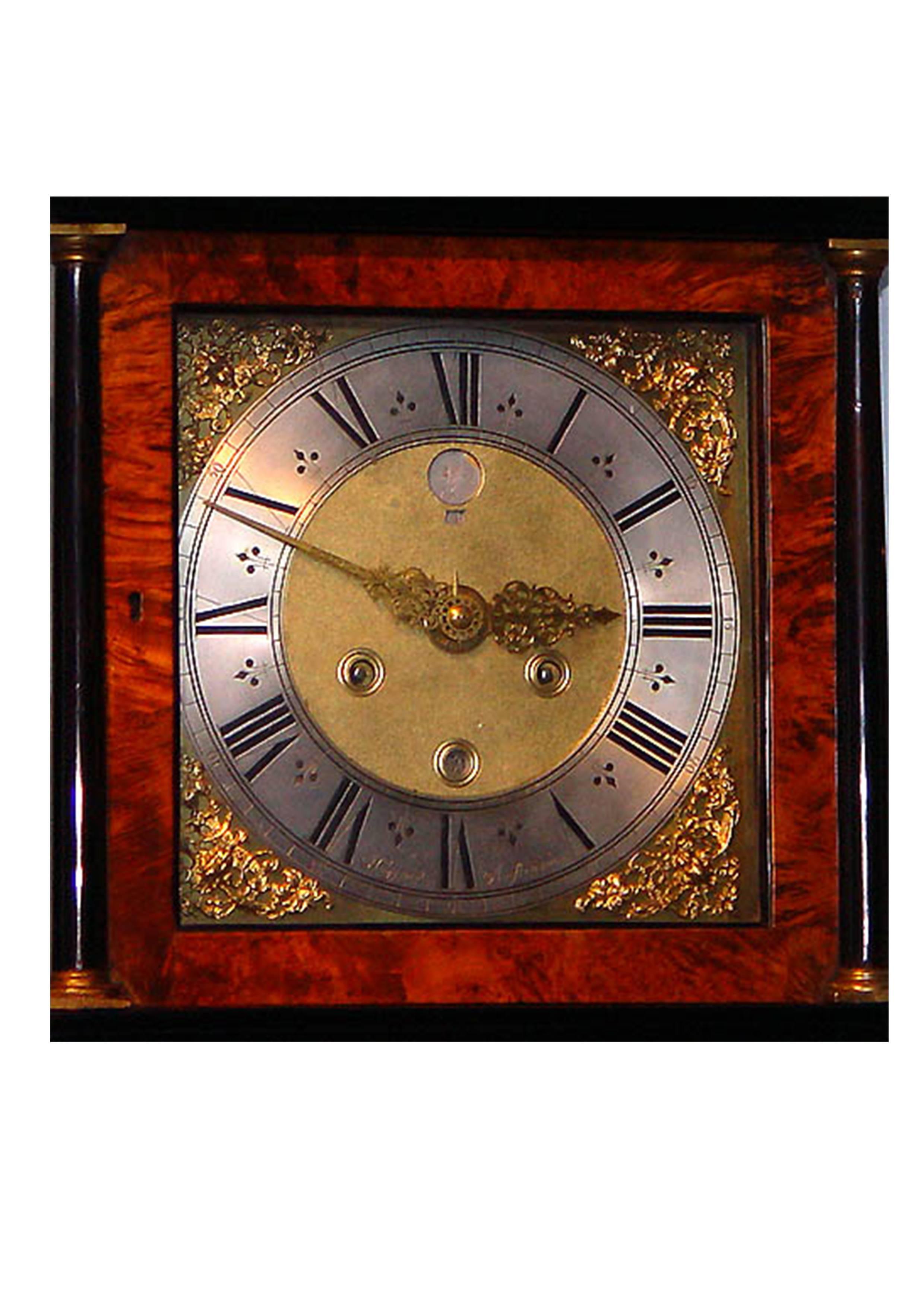 Square brass dial with engraved silvered chapter ring signed Huygens Amsterdam, finely foliate pierced engraved hands with alarm disc, matted centre with ringed winding holes and apertures for date and moonphase with day of the mooncycle, fine