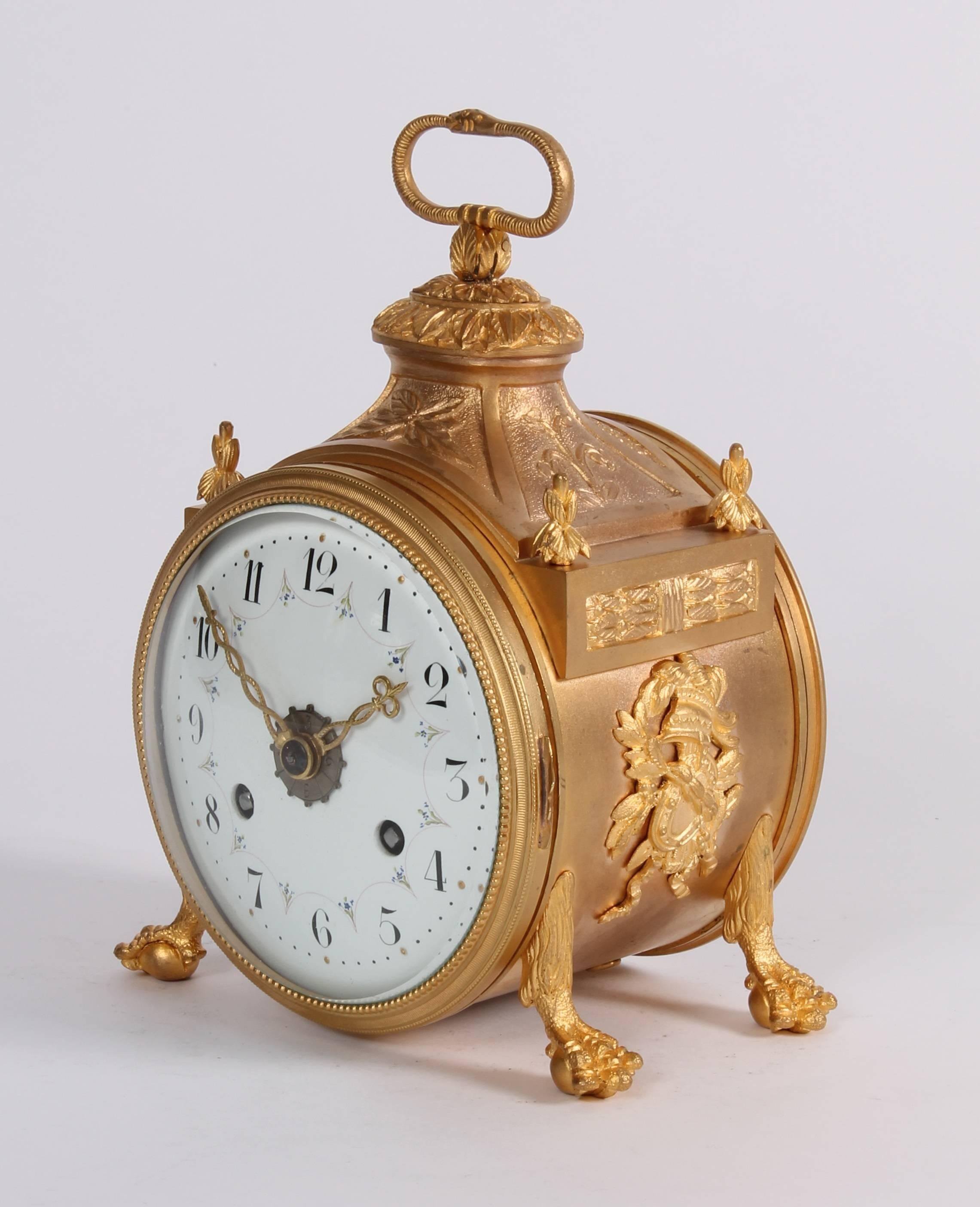 Eight-day spring driven movement with rack half hour striking and alarm on a bell, gilt brass case.

10.5 cm enamel garland dial with Arabic numerals and gilt half hour marks, fine pierced engraved hands and silvered alarm disc, eight-day spring