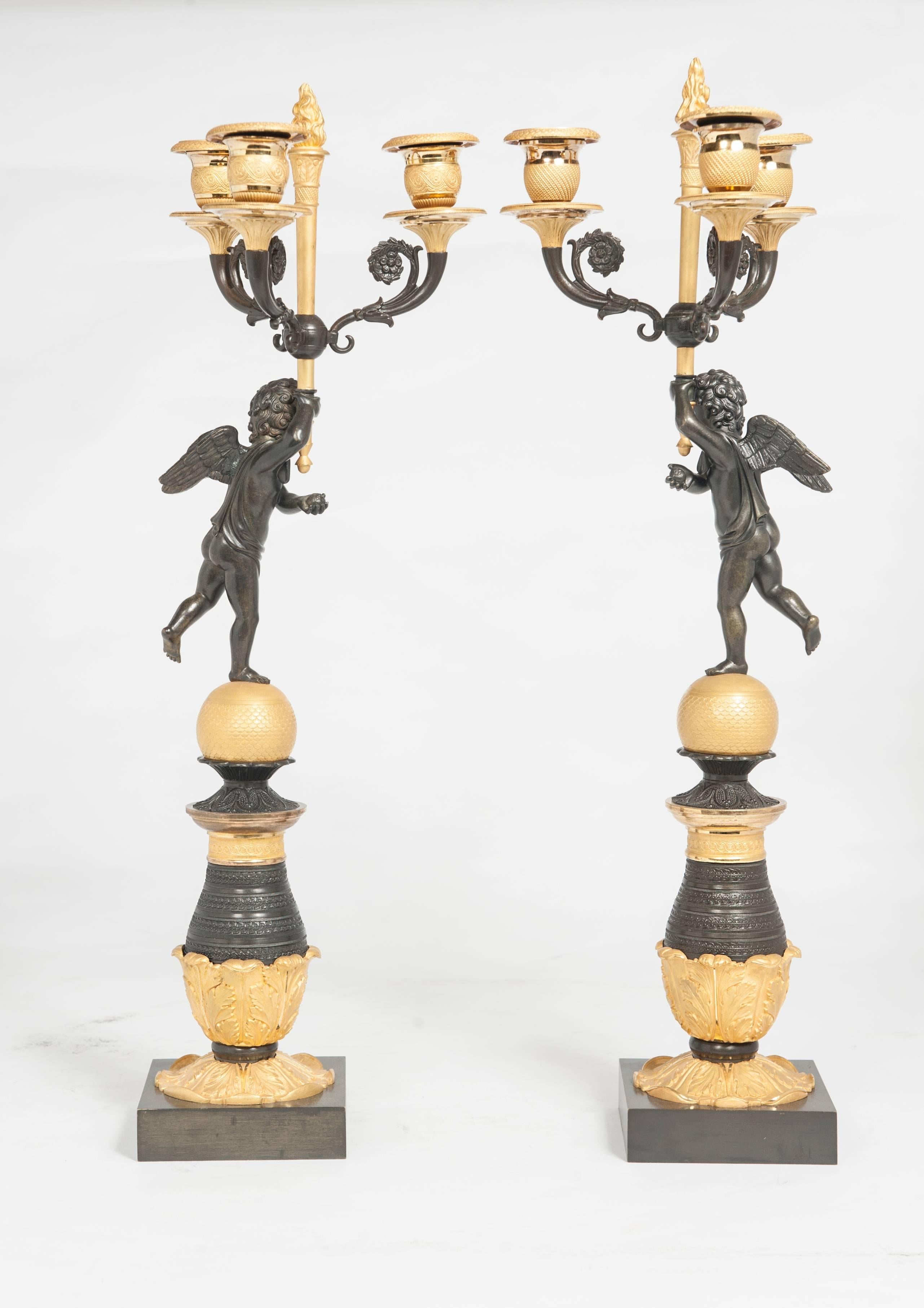 A good pair of Empire/Charles X candlesticks, circa 1830. The nice detailed ormolu and patinated bronzes are from a very good quality.
