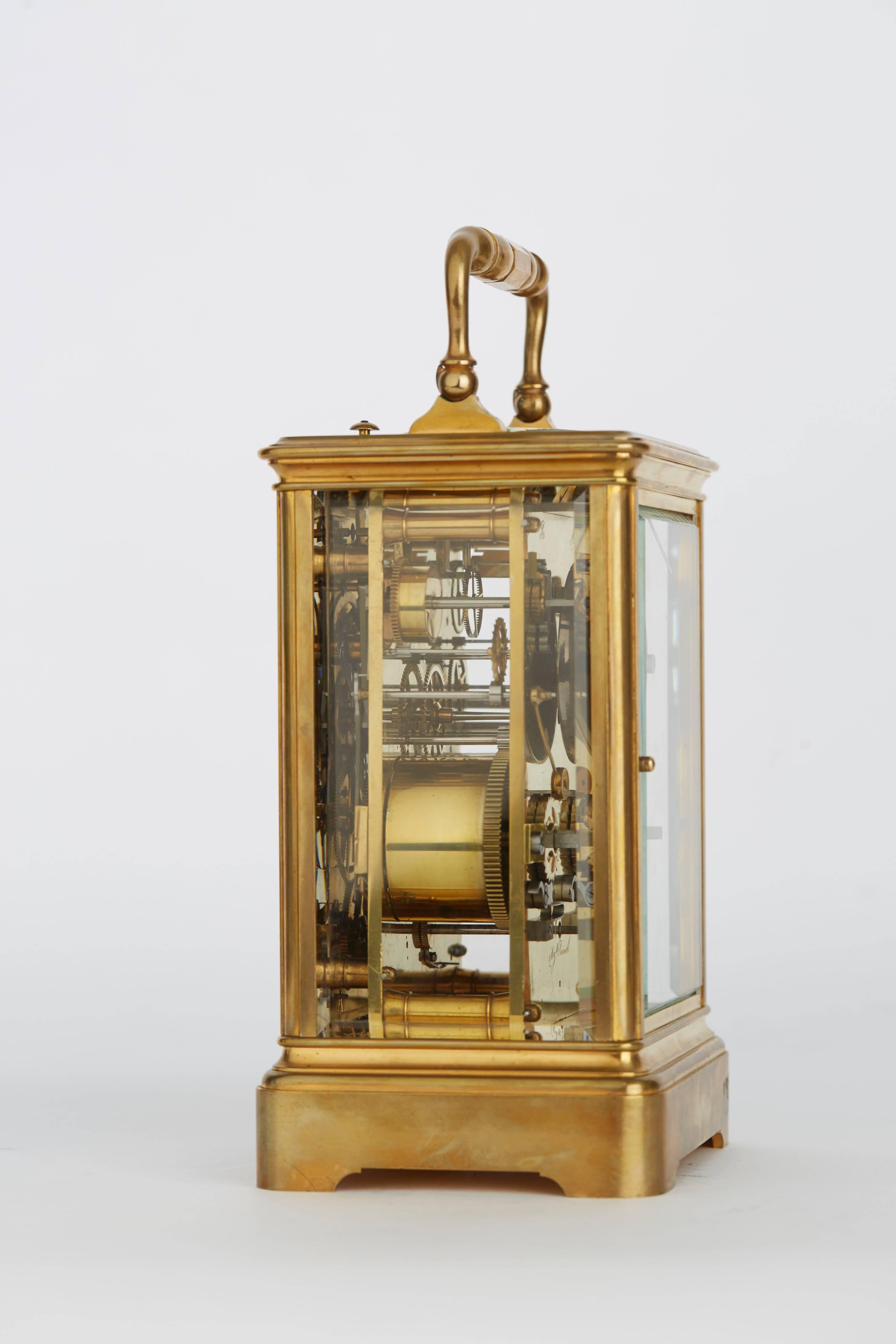 Thomas, 8 Rue Abbatucci, Paris circa 1880. A giant carriage clock with hour strike, repeat and alarm number 211 together with a leather covered traveling box. 
Case: brass, gilt, moulded, facet gazed on all sides and the top, baluster shaped handle