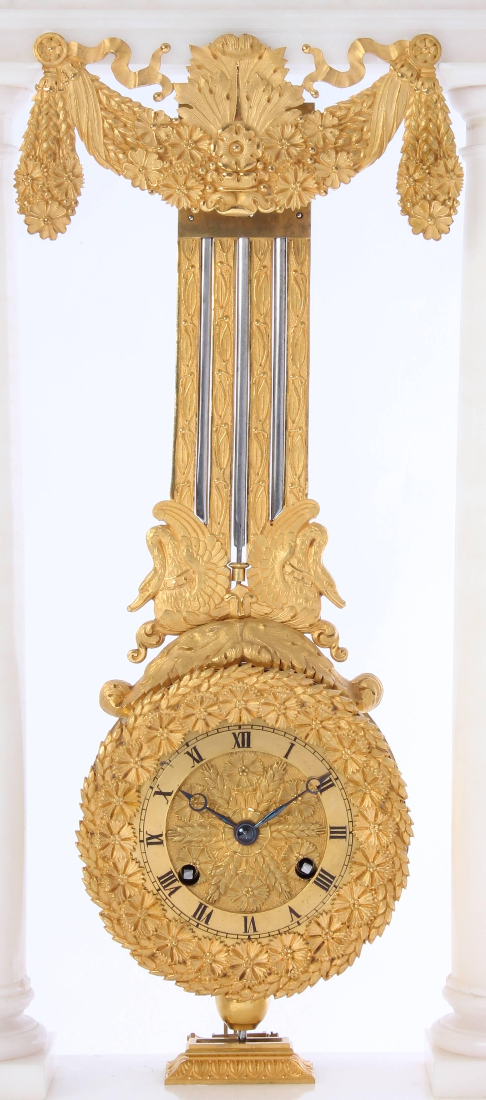 An 8-day spring driven movement clock with hour and half hour strike on one bell. Alabaster case with fire gilt mount, imposing osculating pendant. 

7,5 cm fire gilt bronze chapter ring with Roman numbers and Brequet hands. 