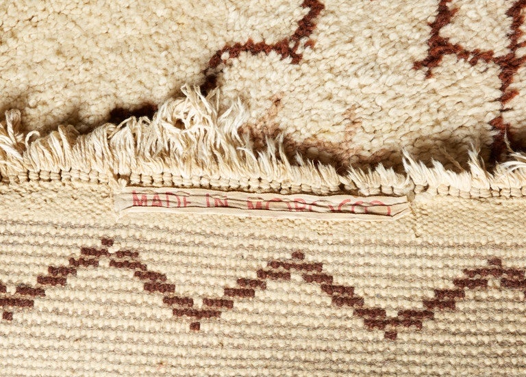 Danish designed rug made in Morocco with geometric pattern cream ground, rust and brown.

With Provenance, original owner purchased in 1961.
Signed: Made in Morocco.