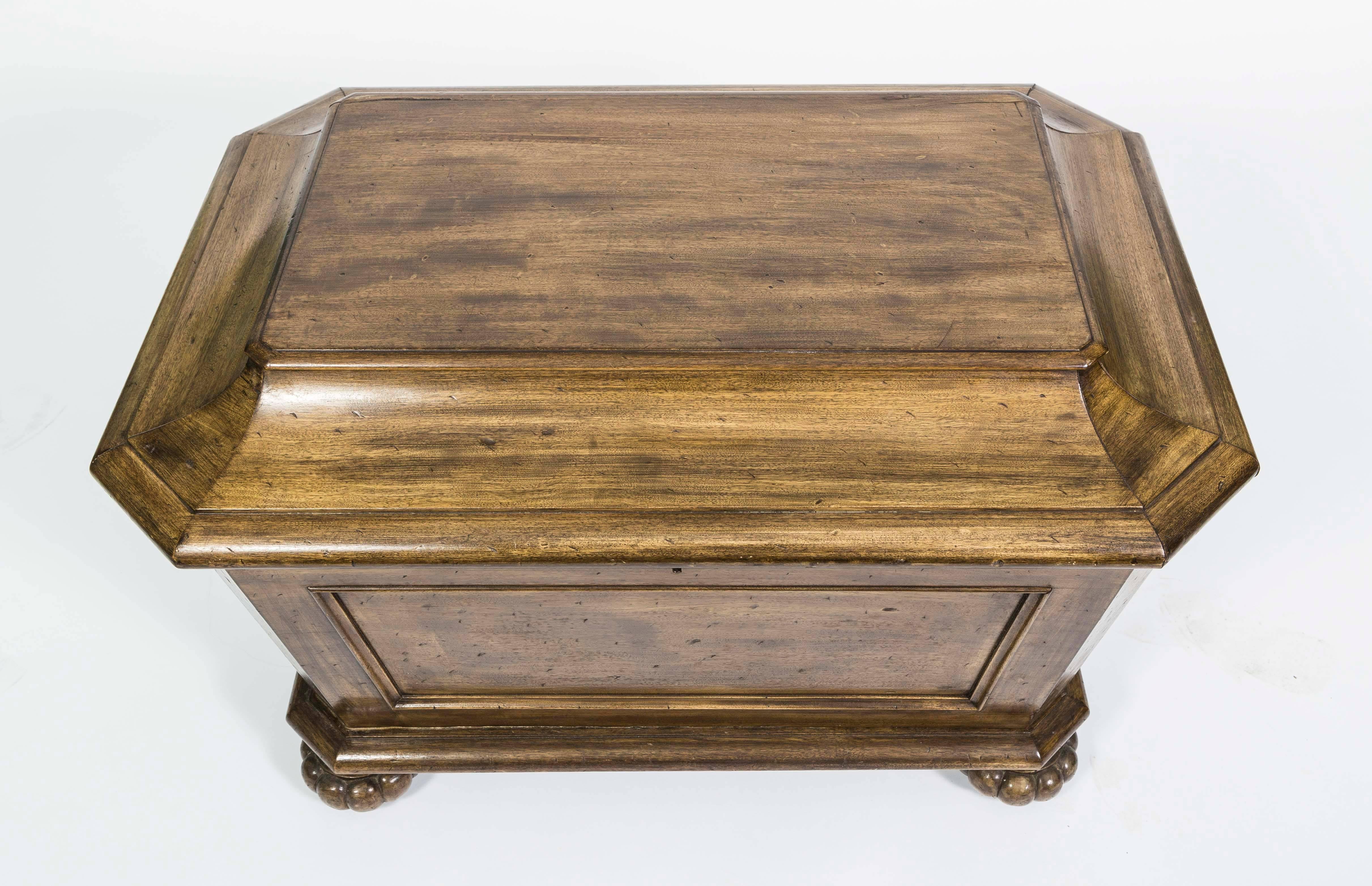 A Victorian sarcophagus shaped cellarette.  The Cooler is made of mahogany and the box features a rectangular top with beveled edges and four bun feet, with a lead lined and divided interior. Has multiple divisions in the interior.  The Cellerette