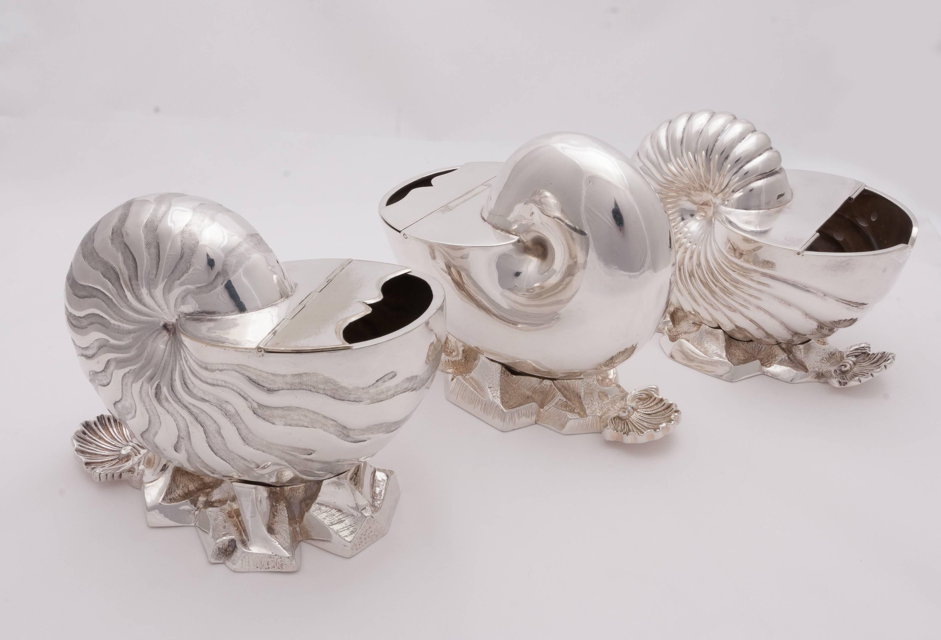This is a beautiful collection of three English Victorian silver spoon warmers in shell form on naturalistic base. Please inquire if you would be interested in purchasing separately instead of a collection.