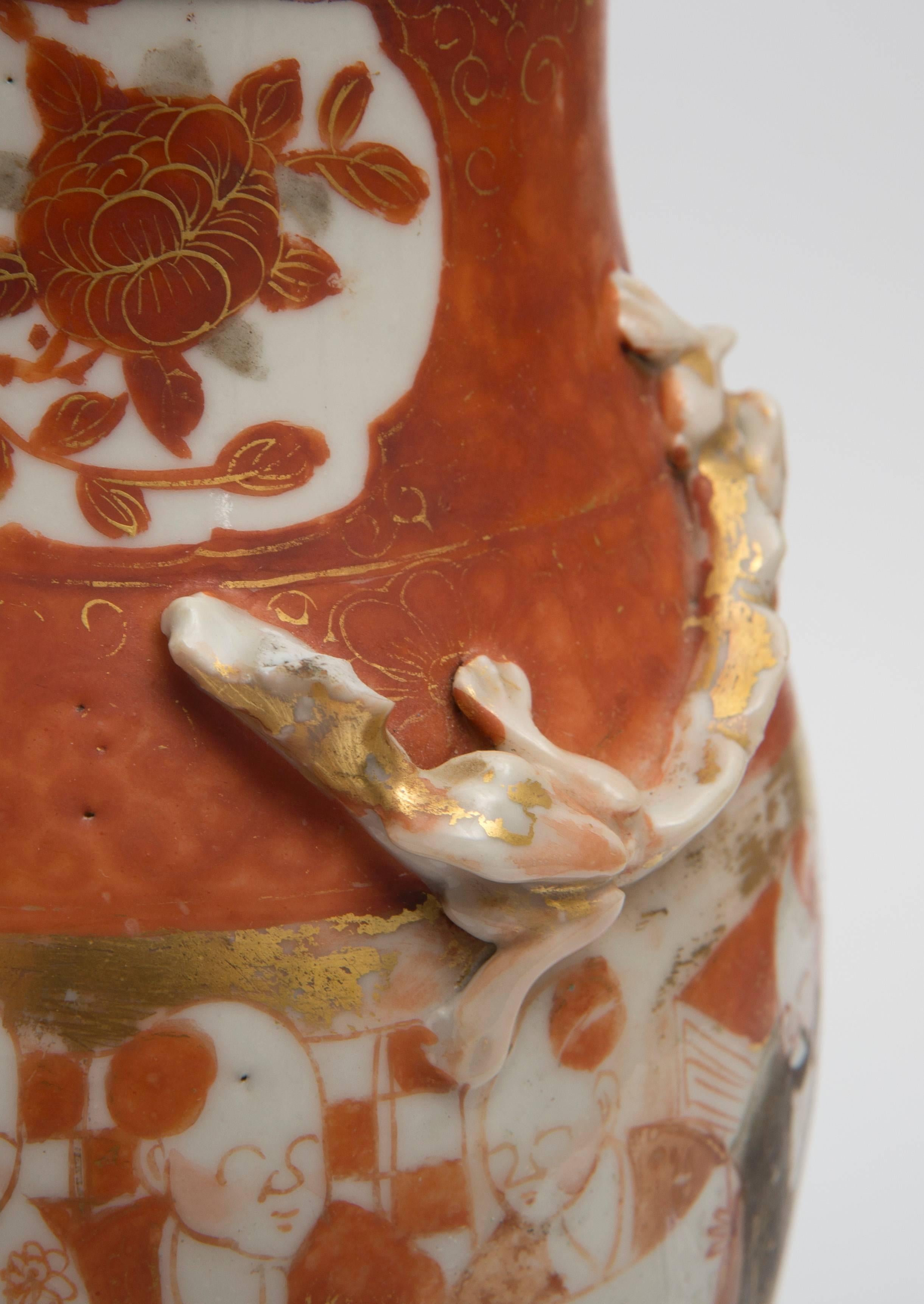 19th Century Canton porcelain vase with oriental motif repurposed into a lamp set on a rosewood base. The colors are orange, black, white and gold.  