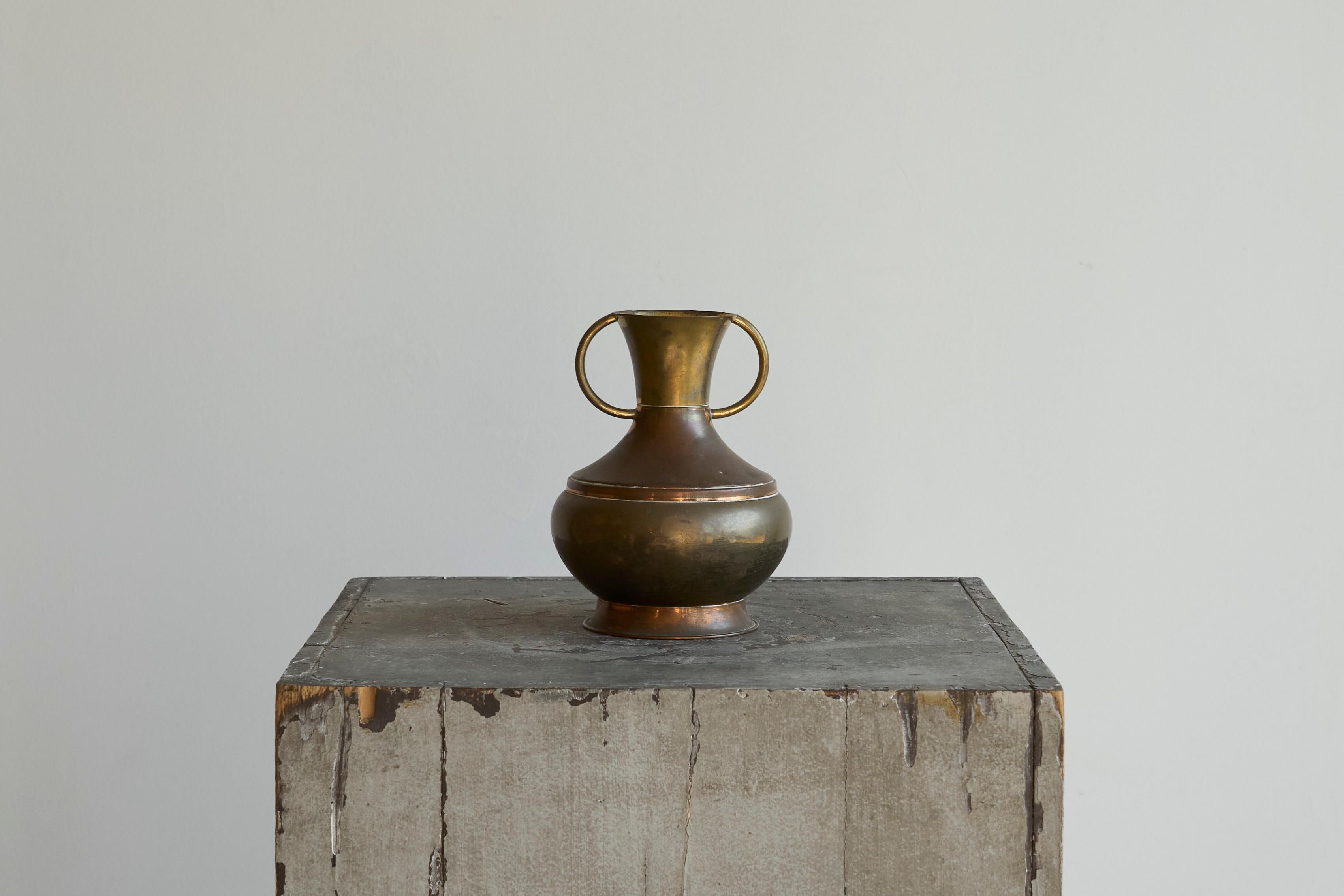 Art Deco Vase in Two Tone Brass

An early to mid 20th century art deco vase in two tone brass.

A great design in brass / copper with a sculptural silhouette. The surface carries a warm, aged finish, shifting between brighter and darker hues.