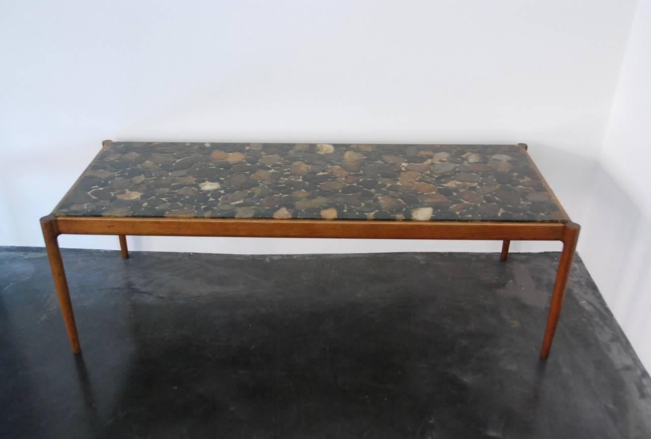 Coffee table with wooden frame designed by Kofoed Larsen for Säffle möbelsnickeri Soffbord, Denmark, 1960s.
Top with rollers in resin, all original condition.